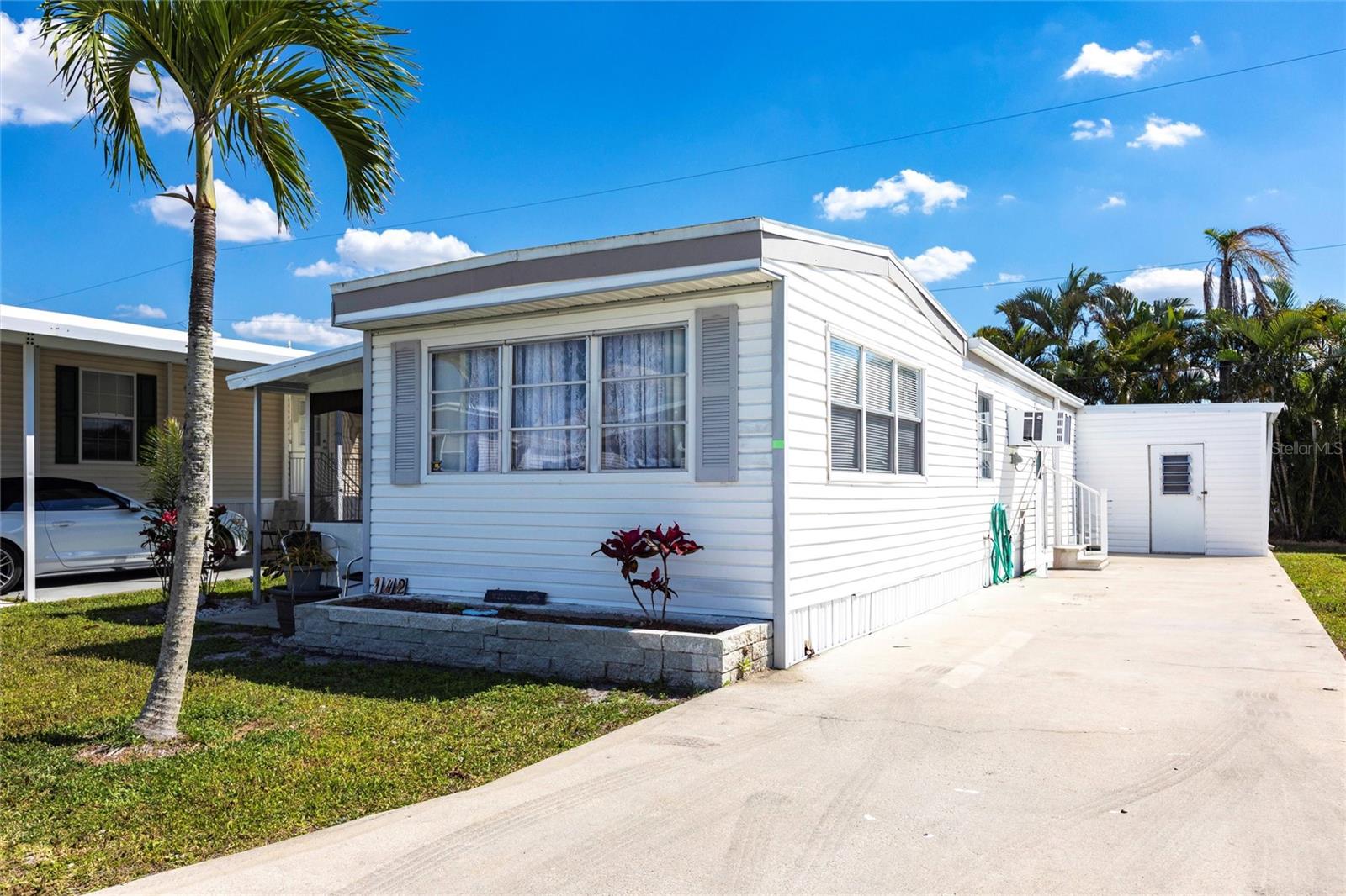 This nicely maintained 1-bedroom, 1-bathroom mobile home offers the perfect blend of modern updates and hassle-free living. Renovated just a few months ago, this home has 564 sq. ft. of stylish, move-in-ready space, situated on a 3,025 sq. ft. lot. Ideal for a first-time buyer, or downsizer, this home is built to last with several recent upgrades, including brand-new siding, a 2024 water heater, new windows on the west side, and a roof that was updated in 2021. As you step inside, you'll immediately notice the bright, open floor plan, featuring updated wood laminate flooring throughout. The spacious kitchen seamlessly flows into the dining area and living room, making it perfect for entertaining or relaxing. The primary bedroom is generously sized, complete with elegant chair railings, while the large full bathroom offers plenty of space for comfort. Additional features include a solid steel-constructed shed, which houses the washer and dryer hook-ups and provides ample storage space. For those seeking outdoor relaxation, enjoy your own screened-in lanai—perfect for unwinding in peace. The home may require the buyer to build/attach a carport. You can take ownership knowing this home was taken care of. The HOA of Parkhill Estates covers Water, Sewer and Trash as well as all Lawn Maintenance and features a community pool, beautiful clubhouse with many activities, boat slips and storage with GULF ACCESS. The current HOA fee is $299 a month. The HOA fee is based on the amount of community shares you own. Shares are $1000 a piece and 5 shares are required to be purchased at closing. The more shares you own the lower the HOA fee. You can own up to 16 shares in total. According to the community, HOA fees can vary between $180-$299 depending on how many shares you own. This property is the best bang for your buck in the area and HOA fees, once you see this property in person, you will not want to see another property.