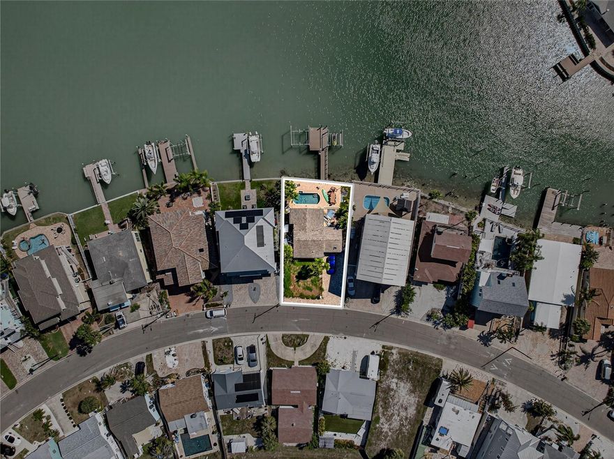 449 S Bayshore Drive, Madeira Beach – Vacant Land LOT SIZE 57x110 An incredible opportunity to build your dream home on beautiful Bayshore Drive in Madeira Beach. The existing home is scheduled to be demoed on 4/29/2026, creating a prime blank canvas in an exceptional waterfront location.  This property already offers valuable improvements, including a pool with two boat lifts—one 20,000-lb lift installed 2021 and one 7,500-lb lift making it ideal for boating enthusiasts ready to enjoy the waterfront lifestyle from day one.  Madeira Beach is known for its laid-back coastal charm, easy boating access, stunning Gulf beaches, and vibrant local dining and entertainment. Just a short walk to the beach, this location truly offers the best of both worlds boating and beach living.  You simply can’t get better than this!