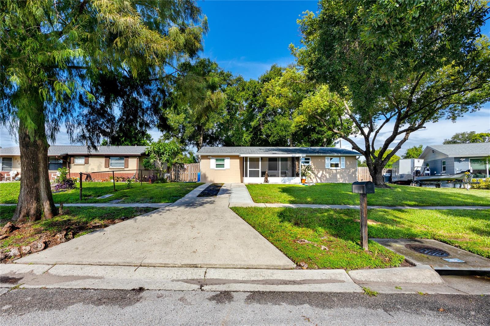 Welcome to this beautifully updated 3-bedroom, 2-bath single-family home in Pinellas Park, perfectly situated on a quiet, well-kept street with outstanding curb appeal, mature tropical landscaping, and no HOA. This high-and-dry property offers a relaxed Florida lifestyle without restrictions—ideal for those who value freedom and flexibility. Step inside to a bright, open floor plan featuring beachy luxury vinyl plank flooring throughout, a spacious living and dining area, and a kitchen with stainless steel appliances that flows seamlessly into the entertaining spaces. Hurricane-rated windows and doors provide peace of mind, energy efficiency, and added storm protection. The home is being offered partially furnished, making it even easier to move right in. Enjoy the outdoors year-round with both a large screened-in back patio overlooking your private, fully fenced backyard and a charming screened front porch perfect for morning coffee or evening relaxation. The property also has reclaimed water hooked up for efficient lawn and garden care. Inside, you’ll find two full bathrooms, generous closet space, and the convenience of an inside laundry room with a washer and dryer included. Nearly every feature has been refreshed, offering true turnkey living. This prime Mid-Pinellas location puts you just up the street from England Brothers Park, known for its community festivals, concerts, and events. You’ll also find numerous other parks, equestrian facilities, the city library, City Hall, and the local Theater for the Performing Arts nearby—making it easy to enjoy all that Pinellas Park has to offer. Plus, you’re just minutes from shopping, dining, schools, St. Pete–Clearwater International Airport, and major roadways for a quick trip to the Gulf beaches, Downtown St. Pete, or Clearwater.
