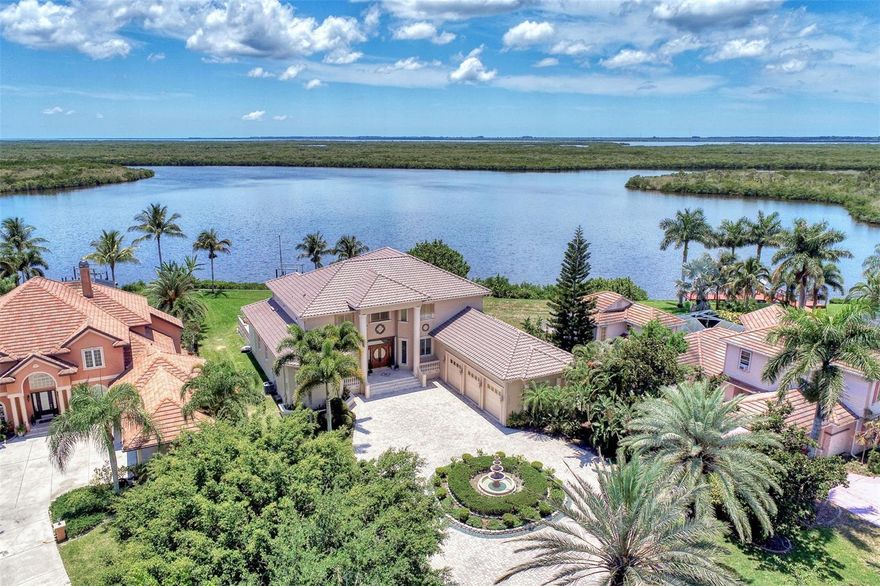 Most Elegant & Sophisticated SAILBOAT ACCESS 2-story Mediterranean style estate pool & spa home offering 4 bds., 3.5 baths, and 3 car garage (Tesla hook-up) & over 5300 sq.ft. of luxury living! This home is located on almost 1 acre, directly on the Manchester waterway with a private NEW boat dock, 10,000 pound boat lift & concrete seawall that leads out to the Gulf of Mexico. NEW soffits and fascia all around the home! Once through the iron gate (NEW keypad), you'll drive down the beautifully landscaped circular driveway to the gorgeous fountain in the center. Tall mature palms and lush green landscaping take you to the elevated front entrance. This home is in South Bayview estates, an area of upscale waterfront homes w/ a fee of only $60/yr. You'll love the expansive view of blue waters from everywhere in the home! On the 1st floor you'll find travertine marble flooring, marble columns, crown molding, soaring ceilings & a beautiful marble fireplace. The pool has been newly surfaced with coral reef & dolphin design and features a spa, swim up table & sun shelf area. The patio also features an outside summer kitchen! The chef’s kitchen is equipped with a center island w/built-in sink & wine refrigerator. Enjoy granite countertops & large breakfast bar, 42’ cherry wood cabinetry, tumbled marble backsplash, sub zero refrigerator, wolf stove top with pot filler & Cafe stainless steel appliances. The kitchen overlooks the family room w/wood accent lighted tray ceiling! The master bd. is 14x29 w/double tray ceilings, sitting area, his & hers closets, plenty of storage w/built-in cabinetry & shelving, double French doors leading out to the pool patio w/ peaceful waterfront & swaying palm trees! The master bath comes w/ jacuzzi tub with jets, dual granite vanities & two sided entry to the walk in shower with dual shower heads & seat. Right down the hall is a guest bath w/ granite countertops, sink w/dolphin head faucet, cherry wood cabinet, seascape mural, walk-in shower & frosted glass door leading to the pool! Enjoy working in the upgraded office w/built in oak desk, bookshelves & upgraded octagon ceiling w/wood design & upgraded paddle fan. On the 1st floor you'll find a large inside utility rm w/granite countertop, built-in cabinetry & sink, crown molding & front load washer/dryer. The oak & wrought iron staircase will lead you to the 2nd floor where you’ll find a 2nd master suite w/ private bath & entry to the 2nd patio. Upstairs you'll also find the 3rd & 4th bedroom, a large game rm, exercise rm & best of all the movie rm with 7 leather reclining movie chairs, granite serving station w/ built-in sink, large movie projection screen, speakers, projector & half bath! The great rm & exercise rm both lead to the 2nd floor balcony patio w/built-in fireplace & wood ceiling! The great room is being used as a recreation room & offers a built-in wet sink, beverage cooler & cabinetry. Top & bottom patios have concrete spindles (balustrades) bordering both outside patios! Extra upgrades include: new pool heater, central vacuum, intercom & security system, in wall pest control, 2 mana bloc systems, mosquito mist around exterior, 3 air conditioning units (1 newer), 5 cat wiring w/separate unit, Sonos sound system wired throughout, water softener, new tile slate roof (2021), accordion & clear hurricane shutters & more! Per seller, home has never flooded or had any leaks from hurricanes! Location is minutes to downtown Punta Gorda shops & restaurants!