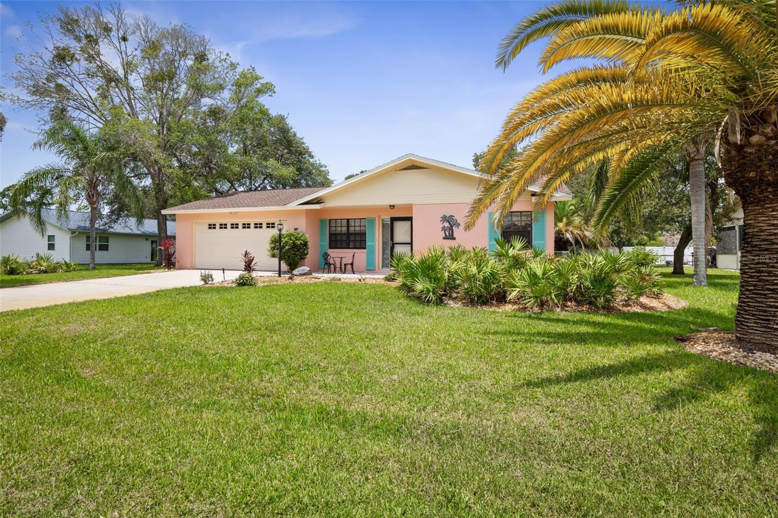 Don't miss your chance to scoop up this classic, well-maintained home in the quiet, established Palm Coast subdivision of Palm Harbor with mature trees and lush landscaping. Lightly lived-in as a second home, this property features a spacious open split floor plan with abundant natural light. Roof replaced in 2022 and A/C in 2012. Bathrooms include skylights for added brightness. Two large guest bedrooms offer flexibility for family, office, or hobbies, while the primary suite includes private access to the screened lanai. Enjoy peaceful views of the beautifully landscaped backyard and Florida wildlife from the covered lanai. Clean, move-in ready, with plenty of potential to add your personal touch and make it your own.