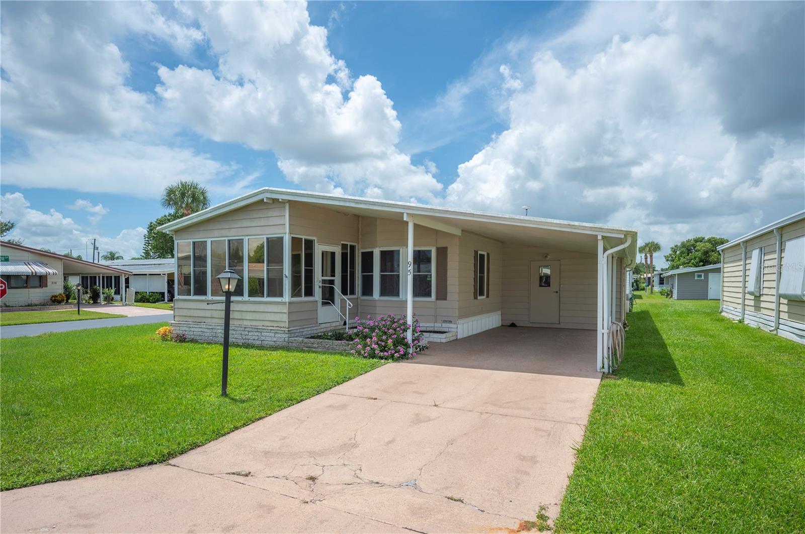 This 3-bedroom, 2-bath home located in the community of Orange Manor West is perfect for settling into an active community for the 55+. The home features metal roof, vinyl siding, carport, outside storage and corner lot. Inside home has a spacious living /dining room combo, a nicely sized open kitchen, inside laundry room, with luxury vinyl and carpet highlights the interior. The community of Orange Manor has an active community with pool, putt putt golf, clubhouse, and other amenities. Located conveniently in Southeast Winter Winter Haven with ease of access to Highway 27. Check this one out today! *Agents, please read MLS remarks.*