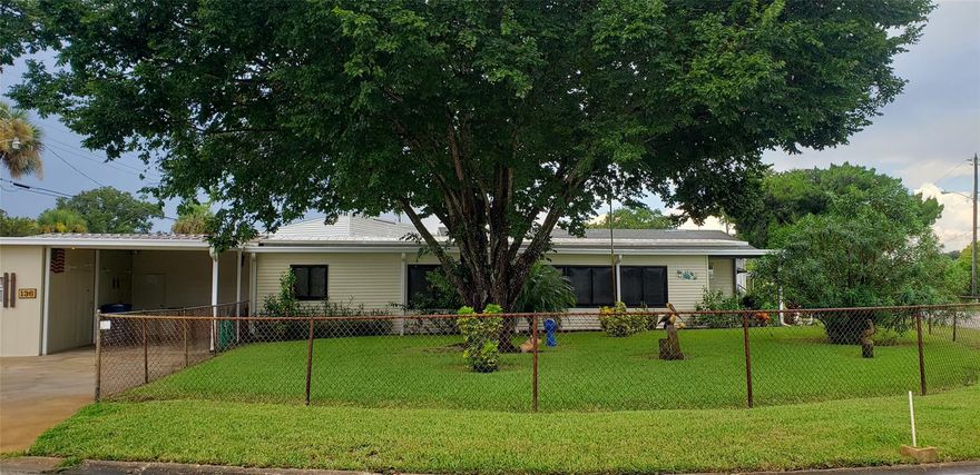 Come and enjoy the quaint charm of this hidden gem located in a riverfront fishing village.  This 2 bedroom 1.5 bath is situated on a corner lot 2 blocks from the river.  This golf cart community offers 350' of fishing pier, boat launch, community club house, community BBQ grill, 2 saltwater swimming pools, boccie ball court, shuffleboard court, basketball, on site laundry facilities and is a family park.  Low amenity fees of $125.00 per month.  This home boast a 51.3 front addition that complements the original home.
The well manicured corner fenced in lot offers a variety of plants and shrubs as well as a beautiful shade tree situated on an oversize lot. ;Water: City