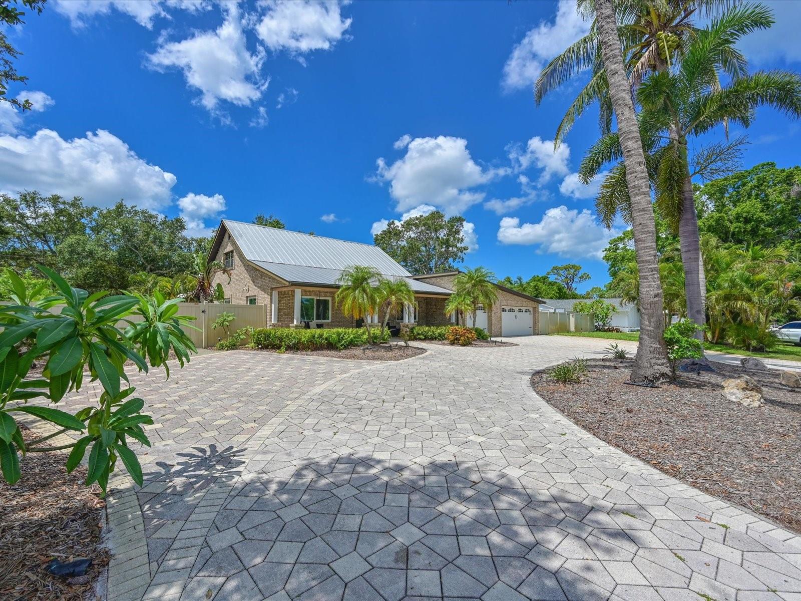 Welcome to Palma Sola Park! This West Bradenton location is in one of the most sought-after locations in Manatee County. This is a multi-use property that works as a fantastic single family home or income producing property. The 4 bedroom 2 bath home has curb appeal as soon as you arrive. With its beautiful brick circular driveway and 3 car garage there is plenty of room for family and friends to park. Welcome them from your 33' covered front porch that is a wonderful transition into the home. This unique home has a large game room complete with poker table and table games. Easy to care for travertine floors cover the downstairs living areas with the 2 downstairs bedrooms having easy care popular vinyl plank flooring. The bathroom on this floor has a large vanity and tub and access to the pool and outdoor entertaining area. The well-equipped kitchen offers wood cabinetry with easy close drawers and a large walk-in pantry and breakfast bar. A glass top range, side by side refrigerator with water dispenser and microwave are included. There is even a dry bar with a beverage refrigerator ready to prepare food a beverages for intimate dining get togethers or large parties. Upstairs the primary bedroom and a guest room share an oversized bathroom with jetted soaking tub and large walk in shower.
The massive living room can host a large family or guests. Two sets of French doors invite you to step outside to a tropical retreat with large heated pool and spa that is remotely controlled and enclosed with screen enclosure. A covered lanai area is wonderful for meals while feeling connected to the outdoors. There is even an area with a firepit and chairs to relax and enjoy those rare, cool Florida evenings or to take a try at making smores!
The guest house has a separate private entrance and boosts a large living space, well equipped kitchen, stacked washer and dryer and 2 sets of sliding doors to access the pool area. House your guests here or rent for additional income.
There is a single car garage and a 2 car for a total of 3 enclosed spaces for vehicles.
The double lot yard is fenced with vinyl fencing for privacy creating a large space for outdoor games or secure parking for an RV, boat or other water toys.
Take a short walk to Palma Sola Yacht basin where you can fish and view visiting the visiting manatees . Residents can apply for a boat slip that will give you direct access to Palma Sola Bay. Enjoy a picnic at the park along the bay or just relax and view the fantastic sunsets that Florida is known for.
Palma Sola Park is conveniently located just a short drive to the white sandy beaches of Bradenton Beach, Holmes Beach and Longboat Key. It is a three mile drive to the world-renown IMG Academies. Explore downtown Bradenton for local dining and shopping. Visit downtown Sarasota, just 12 miles away, for local and fine dining and entertainment venues. Sarasota International Airport is nearby and Tampa International Airport is about an hour away, offering you or your guests multiple travel options.