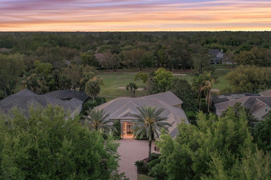 Elegant custom-built Maroon home situated on a sought-after golf-front homesite in Seminole County's premier 24-hour guard-gated golf community of Alaqua Lakes.  This IMPECCABLY-KEPT estate features numerous recent upgrades and enhancements, including a REPLACED TILE ROOF, newer A/C units and water heaters, updated pool equipment, new kitchen appliances, and a beautifully remodeled primary bath.  This incredibly open and airy floorplan showcases soaring ceilings with detail abounding, inviting guests to a shimmering pool and massive covered lanai with tranquil golf vistas.  Arrive at the oversized courtyard entry with brick paver drive, and guests are greeted with double glass front doors.  Upon entry, soaring ceilings and an abundance of natural light showcase the inviting floor plan.  The foyer, living room, and dining room set the stage with captivating views of the golf course, while the kitchen opens up to the family room and massive covered lanai overlooking the sparkling pool(resurfacing pending 4/2026).  The primary bedroom is privately nestled unto itself and features a remodeled spa-quality bath and dual walk-in closets.  The office has its own closet and can make for a 4th bedroom on the main level if needed, while the other 2 bedrooms are situated across the home and share an updated frameless glass shower and bath.  Upstairs, a bonus room with private full bathroom and walk-in closet makes for the ultimate in living space flexibility.  The oversized 3 car garage with high ceiling offer copious storage for all life's incidentals.  As a resident of Alaqua Lakes, you'll have access to a unique 7-acre community park with an open-air pavilion, multipurpose field, tennis courts, and more—all just minutes from top-rated schools, upscale shopping, dining, business centers, and major highways. This property may be under audio/visual surveillance.