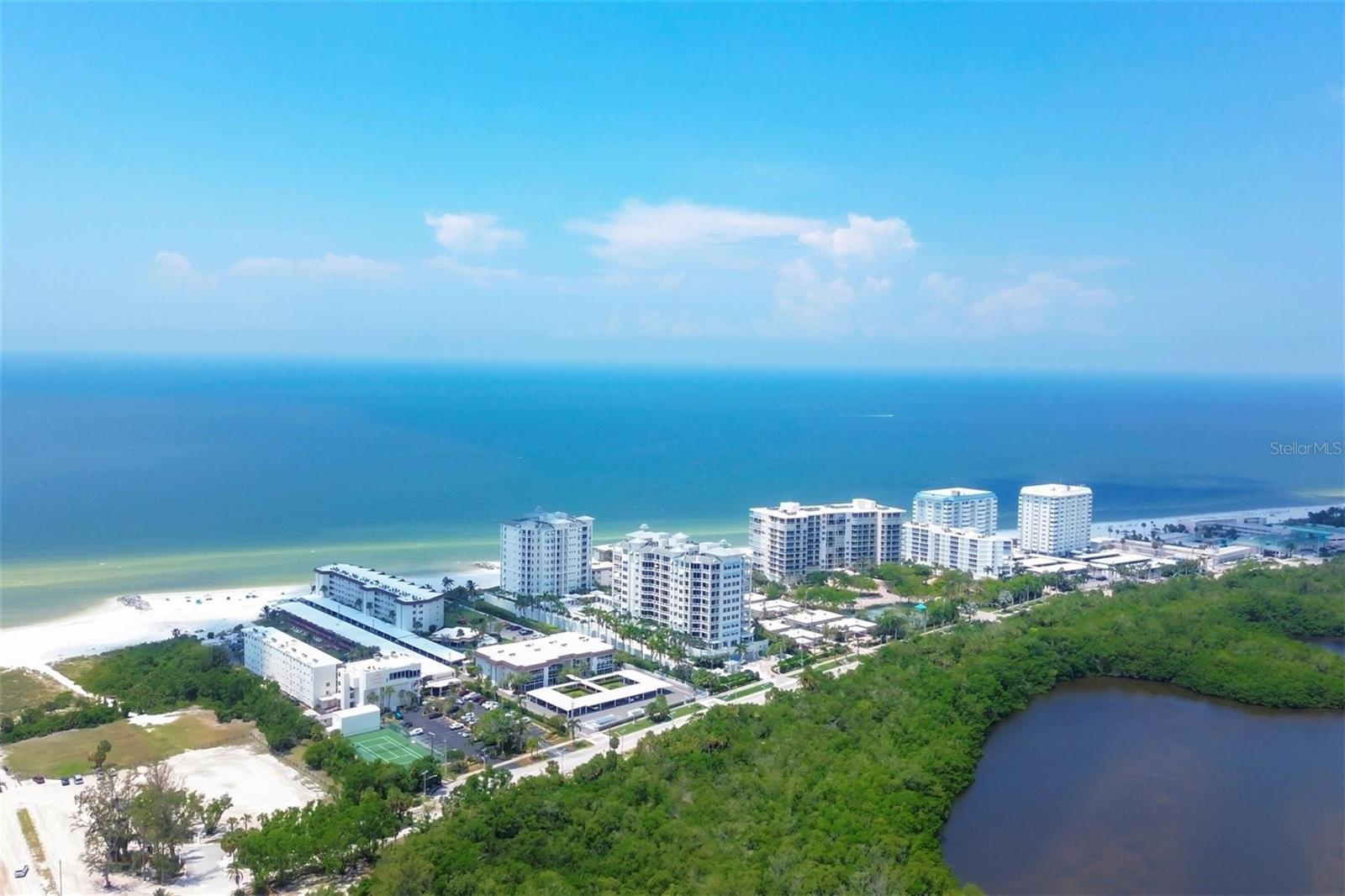 Looking for a rental at the beach. This 2 bedroom, 2 bath is turnkey furnished is being offered as an annual or a season rental. Price is higher in season. A second floor end unit with glass enclosed lanai complete with impact glass. Lido Harbour South has a great beach lifestyle. A sunset deck complete with viewing chairs, lounge chairs for sunbathing on a windy beach day and dining tables and chairs. A private beach access to the Gulf of Mexico allows easy access for a day at the beach, a short stroll to the Ritz Tiki Bar or to the Pavilion at Lido Beach. The community pool is nestled between the building and the clubhouse. You can't beat the location. Ted Sperling Park is just outside the gate. This nature park has access to the mangrove tunnels for kayaking, the intercoastal waterway for watersports, viewing of dolphins, manatees and numerous shorebirds. The Bay Runner stop is steps away for easy transportation to the St Armands Circle or Downtown Sarasota.