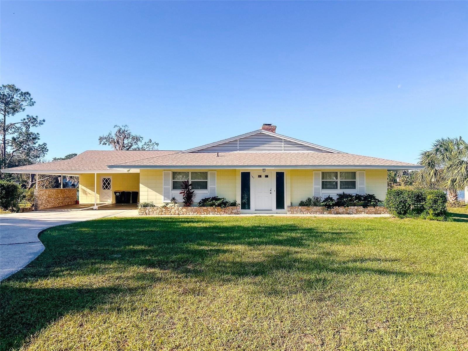 This charming lakefront home features four bedrooms and three bathrooms, offering a spacious 2,747 square feet of living space on a generous 1/3-acre lot with a stunning yard. Built in 1962, it presents a wonderful opportunity for a family to create their dream home by renovating the classic design to reflect their personal style. Families will appreciate the inviting double-sided fireplace and the expansive bar area, perfect for entertaining friends and loved ones. The inground pool, complemented by a screened lanai, adds to the outdoor enjoyment, making it an ideal setting for summer gatherings and relaxation. This home is a canvas for memories waiting to be made! Bring the boat, this home is a keeper!