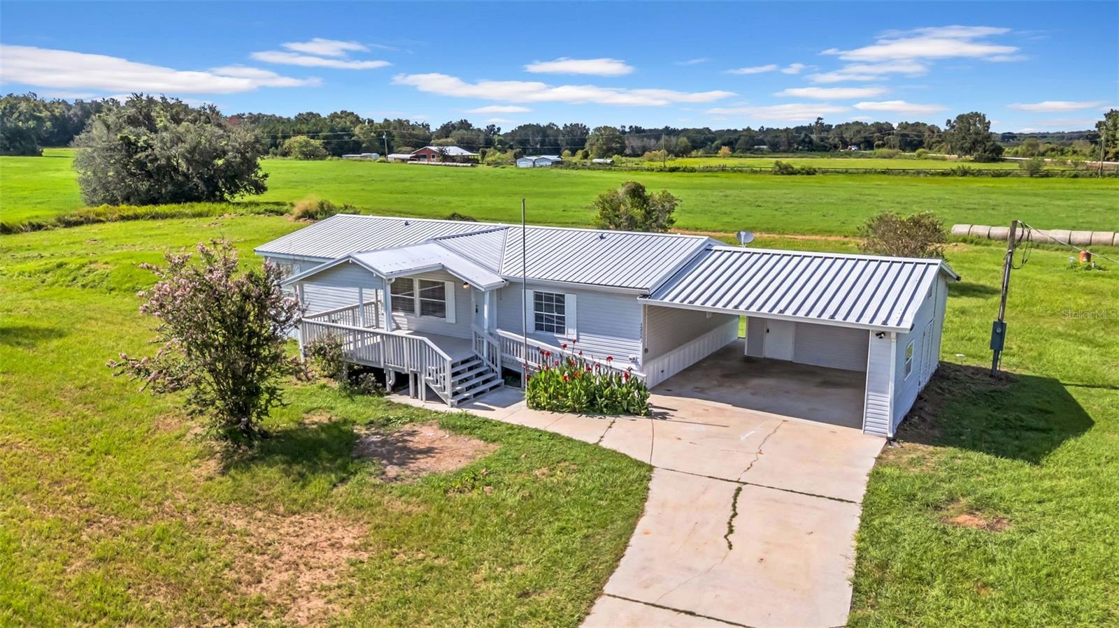 Move-in Ready Home on 1.5+ Acres in Dade City
Welcome to your beautifully updated 3-bedroom, 2-bathroom home, set on 1.59 acres of peaceful Florida countryside. Every detail has been carefully refreshed so you can move right in and enjoy. Step inside to a bright, open interior with new flooring throughout, freshly textured walls and ceilings, and a full interior paint job. The kitchen shines with brand-new appliances, updated counters, and modern hardware, while both bathrooms have been completely refreshed with new vanities, mirrors, lighting, and toilets. All major systems have been serviced, including the AC, well, and electrical, with every inspection item addressed for your peace of mind. Outside, relax or entertain on the brand-new front and back decks while enjoying the expansive yard, freshly landscaped with trimmed trees, new plantings, and mulched beds. The roof has been professionally cleaned and confirmed leak-free, and exterior updates include painted trim and doors, pressure-washed surfaces, and new locks and handles throughout. Additional highlights include a reconfigured laundry room with new washer and dryer, updated lighting and closet systems, and full pest control treatment both inside and out. No HOA or CDD make this little slice of paradise that much more affordable. This property blends modern comfort with the space and serenity of country living — all just a short drive to downtown Dade City’s shops, dining, and events.