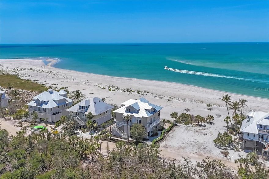 Beachfront Paradise on Palm Island – Unmatched Coastal Luxury!
Experience the ultimate in island living with this exceptional beachfront home located within the exclusive Palm Island Resort, offering stunning panoramic views of Stump Pass, Boca Grande and unforgettable sunsets over the Gulf of Mexico (America). Thoughtfully designed with quality construction by Southern Design Home Builders and attention to detail throughout, this coastal retreat blends timeless elegance with casual comfort.
Currently configured as a 3-bedroom, 3-bath home that sleeps ten comfortably, it has a library/office easily convertible to a 4th bedroom. The third bedroom is configured as a kids' bunk room. The open and airy floor plan is designed for relaxed entertaining. The spacious, screened lanai with a lower outside deck invites you to experience refreshing coastal breezes and the soothing sound of the waves, while the stunning great room with a soaring 25-foot ceiling—adorned with walls of windows and anchored by a cozy fireplace—offers warmth and charm on cooler evenings.
The chef’s kitchen, equipped with plenty of counter space, a large 5-burner cooktop, double ovens, refrigerator and wine cooler, is perfect for hosting family and friends in the adjoining dining area with its views of the beach. The adjacent butler's pantry/laundry room with utility sink, additional full-size refrigerator and work desk is a great complement to the kitchen. The upstairs master suite is a true private retreat featuring a private sundeck, luxurious computerized step-in shower, large walk-in closet, beverage cooler, and a wall of windows framing endless Gulf views.
Additional highlights include: automatic, battery-operated shades for ease and comfort, a three-stop elevator for convenient access, 10 ft ceilings throughout, 22 KW generator for added peace of mind, a shed with a massive storage area for all your island toys, two finished attic areas, and a new metal roof, newer AC units, a newer tankless hot water heater and a fully built-out deck below the home which allows for you to enjoy the outdoors regardless of weather. You’ll also appreciate the large outdoor shower for after a day spent at the beach!
Enjoy quiet walks (often not seeing another beachgoer for miles) along the 7 miles of pristine, sandy beaches, collecting shells and sharks' teeth, or simply relax and embrace the laid-back lifestyle that Palm Island is known for.
Palm Island Resort amenities include bell service, Rum Bay Restaurant, pool and spa, security, tennis and pickleball courts, playground, dockage and more. Access to the island is easy via a quick car ferry ride, after which you’ll experience golf-cart-only transportation throughout the resort, ensuring a truly serene and relaxed island atmosphere.