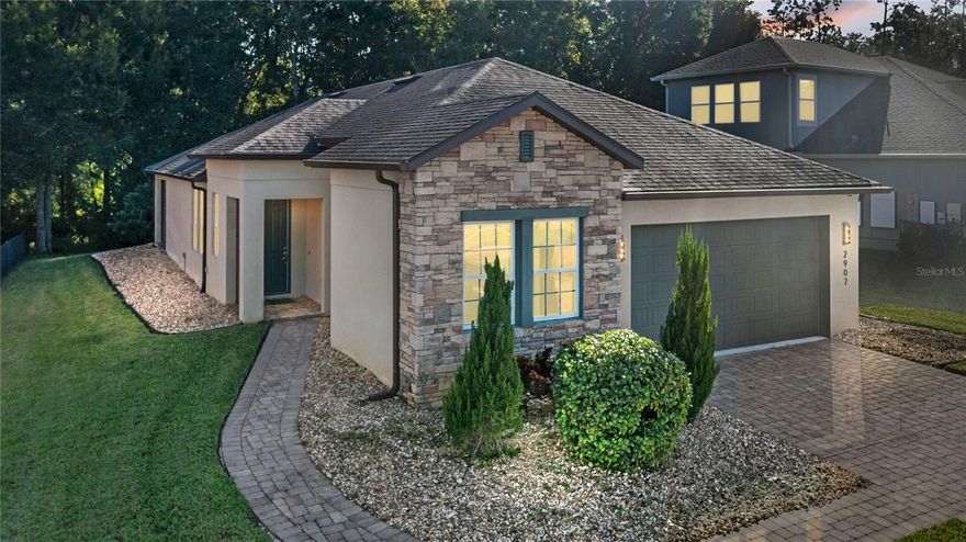 Move right into this former model home from Cal Atlantic Homes in Ocoee’s gated Arden Park North community.  This “Largo” floor plan features 3 beds, 2 baths, family room, dining room, upgraded kitchen, 2 car garage, a large covered patio that backs up to trees – NO REAR NEIGHBORS! You will love the 8’ front door and stone front elevation, tall ceilings, neutral paint palate, crown molding, wood and ceramic tile floors throughout – no carpet – and the open floor plan! The foyer with coffered ceilings will welcome you into the home with the dining room in front of you. The spacious and upgraded kitchen features 42” cabinets with crown molding and hardware, subway tile backsplash, quartz counters with a farmhouse style stainless steel sink, stainless steel appliances with a gas range, breakfast bar, plenty of counter space and a walk-in pantry with a glass French door. The kitchen is open to the large family room, with a French door leading to the brick paver and covered patio that is pre-plumbed for a summer kitchen and backs up to a wooded view for privacy – what a great space to enjoy your morning coffee or relax after a long day! The owner’s suite is in the back of the home, overlooks the wooded backyard and features a tray ceiling with crown molding and wood panels, and an en-suite bath with a double sink “adult height” vanity with two vessel sinks, a glass enclosed, walk in tiled shower with a bench, a walk-in closet with built-ins and a separate water closet. The guest bedrooms are in the front of the home for privacy. One has a built-in desk and wall-unit built into the wall. The guest bathroom has a one sink “adult height” vanity and a tiled tub/shower combo with a large decorative listello design on the wall. The laundry room is off the kitchen and has 42” cabinets for storage, a new washer and built in sink with cabinet underneath. The two car garage floor is epoxied. Additional updates to this home include a water filtration system, a transferrable termite bond, surround sound throughout the home and a built-in security system with cameras and a monitor. Home can be sold with the existing furniture and décor, if the Buyer chooses. Community is gated and features a pool, playground, fitness center and a walking trail around Lake Sims. Centrally located, minutes away from the West Orange Trail, easy access to the 429, downtown Winter Garden, shopping, dining and major highways. Make this beautiful home yours today!