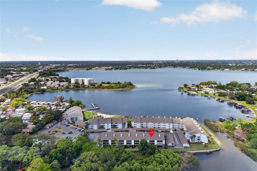 One or more photo(s) has been virtually staged. Welcome to your lakeside retreat in the highly desirable Fairview Vista community! This beautifully maintained second-floor condo (with convenient elevator access) offers the perfect blend of tranquility and city convenience, featuring stunning panoramic views of Lake Fairview from both the living room and primary suite. Step inside to a thoughtfully updated interior featuring fresh paint, ceramic tile flooring throughout, and granite countertops in the kitchen. The spacious layout is filled with natural light, while the oversized balcony is the perfect setting to relax and take in peaceful water views. This maintenance-free community includes Wi-Fi, cable, and resort-style amenities designed for true Florida living. Enjoy a private sandy beach, lakeside pool, boat dock with launch, gazebo, tennis courts, basketball court, clubhouse, and even boat and trailer storage. Whether you're boating, paddleboarding, or simply enjoying the sunset, Lake Fairview becomes your everyday backdrop. Additional features include an in-unit washer and dryer, assigned covered parking, ample guest parking, and a resident-only car wash area.  Ideally located just minutes from Winter Park, College Park, and Downtown Orlando, with easy access to I-4 and SR-408. Enjoy nearby shopping, dining, and entertainment, plus world-famous attractions like Disney, Universal, and SeaWorld all within a short drive. Florida’s beautiful east coast beaches are also less than an hour away.