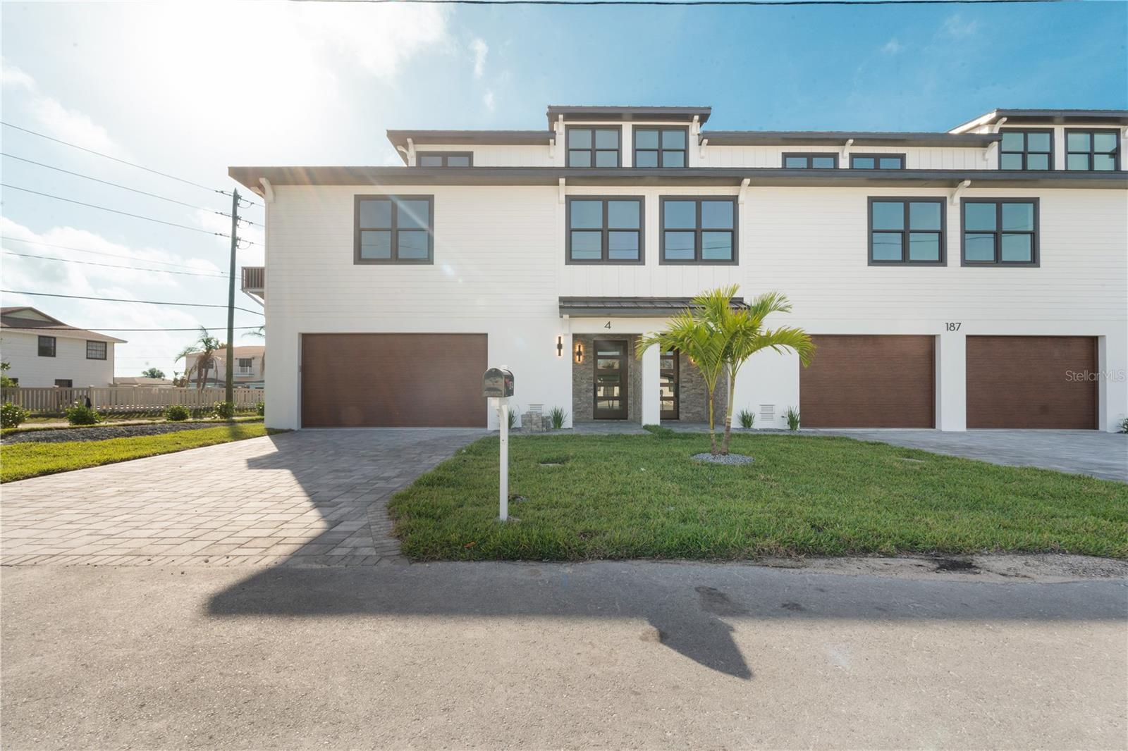 Your Dream Beach Lifestyle—Now Available for Lease with Option to Purchase! Experience the best of beachside luxury living—without the long-term commitment (unless you fall in love, of course!). This high & dry new construction end-unit is the marquee residence of the exclusive Madeira Beach Walk, a boutique 4-condo community. Offering the warmth of a private home and the convenience of a lock-and-leave lifestyle, this is your chance to live the dream now—with the flexibility to make it yours later. Spanning three thoughtfully designed levels, the entire top floor is your personal owner’s retreat, complete with a spacious walk-in closet, oversized en-suite bath with double vanity, and a private balcony showcasing wide-open water views and salty Gulf breezes. The main living level is an entertainer’s paradise: natural light pours in through expansive windows and 10-foot ceilings. The open-concept design centers around a chef’s kitchen outfitted with high-end Viking appliances, an oversized island, under-counter microwave, wet bar with built-in wine fridge, and luxe designer finishes. Extend your living outdoors with a second large balcony perfect for relaxing Florida evenings. Two generously sized guest bedrooms (one with a private en-suite), a full guest bath, a powder room, and a custom laundry room round out the interior, offering functionality without sacrificing elegance. Every inch of the home is elevated with high-end touches—from Kohler fixtures and oversized porcelain tile to quartz countertops and premium hardware. Storage? You’ve got it. A massive 3-car+ garage (~32ft x 45ft) gives you room for everything—beach toys, bikes, golf cart, kayaks, and even a small car collection. It’s larger than most entire beach condos! Located in the most walkable pocket of Madeira Beach, you’re steps from vibrant restaurants, cozy cafés, lively beach bars, and local entertainment—yet quietly tucked into a peaceful residential neighborhood. This rare balance between lifestyle and location makes it one of the most desirable spots on the coast. As a tenant, you’ll enjoy the same benefits homeowners do: HOA dues cover exterior maintenance, exterior insurance, flood insurance, landscaping, power washing, reserves, sewer, and trash—worry-free coastal living! Walkthrough video, finishes brochure, neighborhood map, and full rental + purchase details available upon request. Lease it today, love it forever—ask about our flexible rent-to-own options and private tours!
