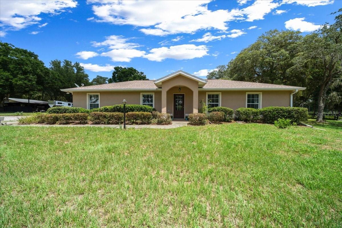 Exceptional Equestrian Property in Marion County's Coveted NW Corridor.
Don’t miss this rare opportunity to own a turnkey horse farm located in one of the most desirable equestrian areas of Northwest Marion County. Set on nearly 7 high and dry acres. The land is beautifully laid out with well-maintained pastures enclosed by safe, no-climb wire and top board fencing—ideal for turnout and peace of mind. There is perimeter fencing around the entire acreage. Mature oak trees are strategically placed throughout the property, offering shade and natural beauty, including in the riding arena area for added comfort during warm training days. The expansive sand arena space could easily accommodate a jump course, dressage arena, or barrels.
The concrete block home offers 3 bedrooms, 2.5 baths, and a spacious split floor plan designed for comfort and convenience. Recently updated with a brand-new roof (2023) and HVAC (2025), and pressure tank (2024). The home features hard surface flooring throughout, an inside laundry room, and a large storage room. A bright and airy sunroom provides a serene spot to enjoy your morning coffee while overlooking the rear paddocks.
Equestrians will appreciate the thoughtfully constructed barn, which includes 6 large stalls, concrete center aisle, a separate air-conditioned tack room, a dedicated space for shavings, and plenty of covered storage for equipment and feed. The adjacent round pen is shaded for comfortable groundwork sessions, and the wash rack adds to the farm’s functionality. A wide, gated entrance makes trailer access a breeze, with plenty of space to turn around and safely unload horses.
Additional amenities include an RV hookup—ideal for seasonal guests or on-site help. With no HOA restrictions and just minutes from the World Equestrian Center (16 miles), HITS (16 miles, Rainbow Springs State Park (5 miles), shopping, feed stores and more, this property truly offers the best rural charm and modern conveniences.