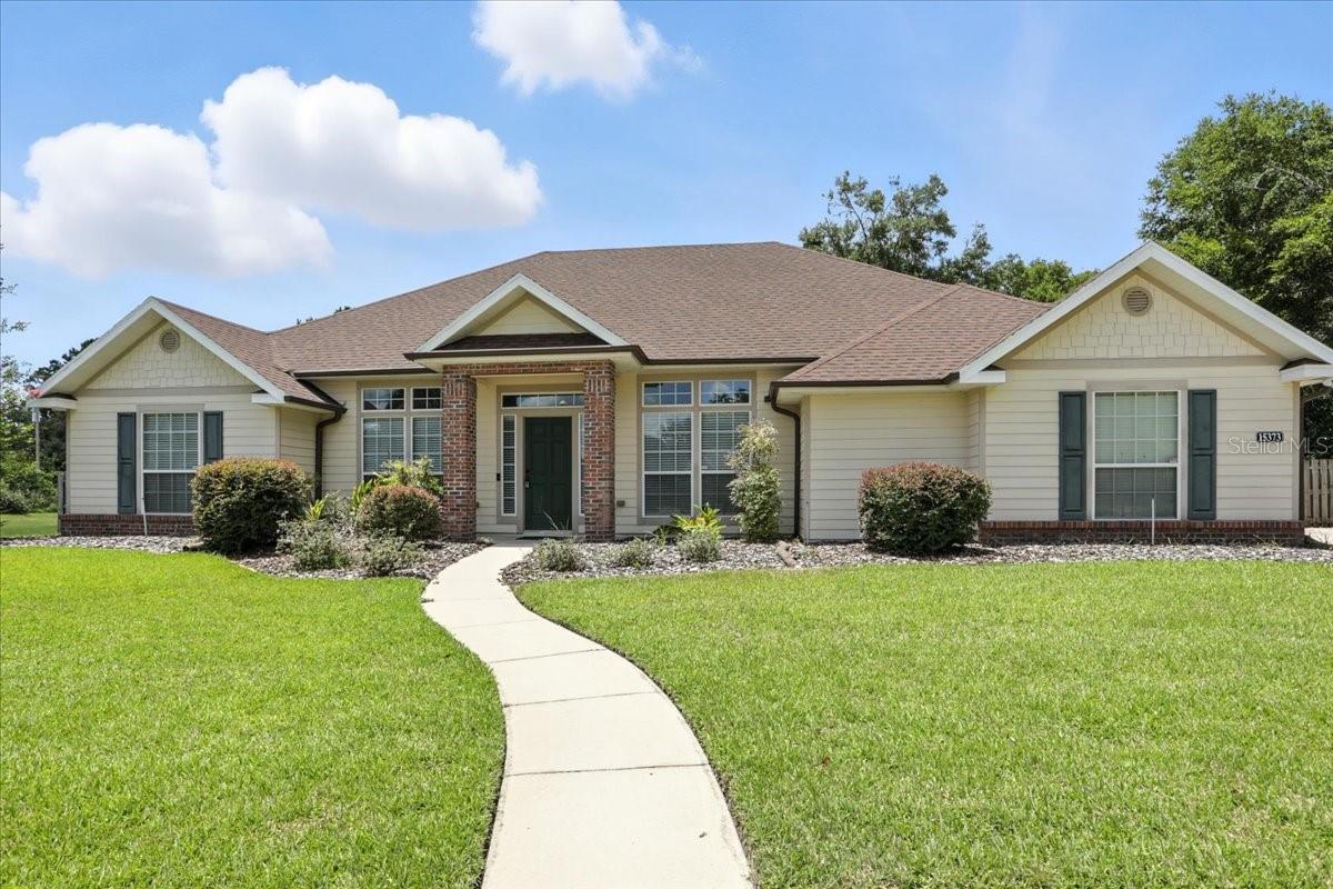 Escape to your dream home in Alachua, where luxury meets lifestyle in this exquisite Hartley Brothers residence, nestled on a serene cul-de-sac within the prestigious Wyndswept Hills gated community. This exceptional 4-bedroom, 2-bathroom home showcases a spacious split floor plan that effortlessly combines open-concept living, dining, and kitchen spaces.
Enter into a versatile front room, perfect for a home office or elegant sitting area, which flows seamlessly into a warm family room and a dedicated dining area just off the kitchen. The thoughtfully designed kitchen is a chef’s delight, featuring premium appliances, a gas stove, and an inviting breakfast bar, making it an ideal space for both culinary creativity and entertaining guests.
Retreat to the generous primary bedroom, complete with a stylish trey ceiling and a luxurious ensuite bathroom that boasts a relaxing garden tub and a walk-in shower. Each of the three guest rooms offers comfort and an abundance of natural light, ensuring a welcoming atmosphere for family and friends. The attached 2-car garage provides not only parking but also ample room for tools, bikes, or weekend projects.
Step outside to your screened back porch, equipped with a gas connection for an outdoor kitchen, and revel in the privacy of your expansive fully-fenced backyard. With serene wooded areas bordering three sides, this outdoor oasis also features an 18-foot above-ground pool, perfect for endless summer fun and relaxation.
Conveniently located just minutes from Main Street in downtown beautiful Alachua, and only a short drive from Gainesville, this home embodies the ultimate in high-end comfort and convenience. Schedule your private showing today!