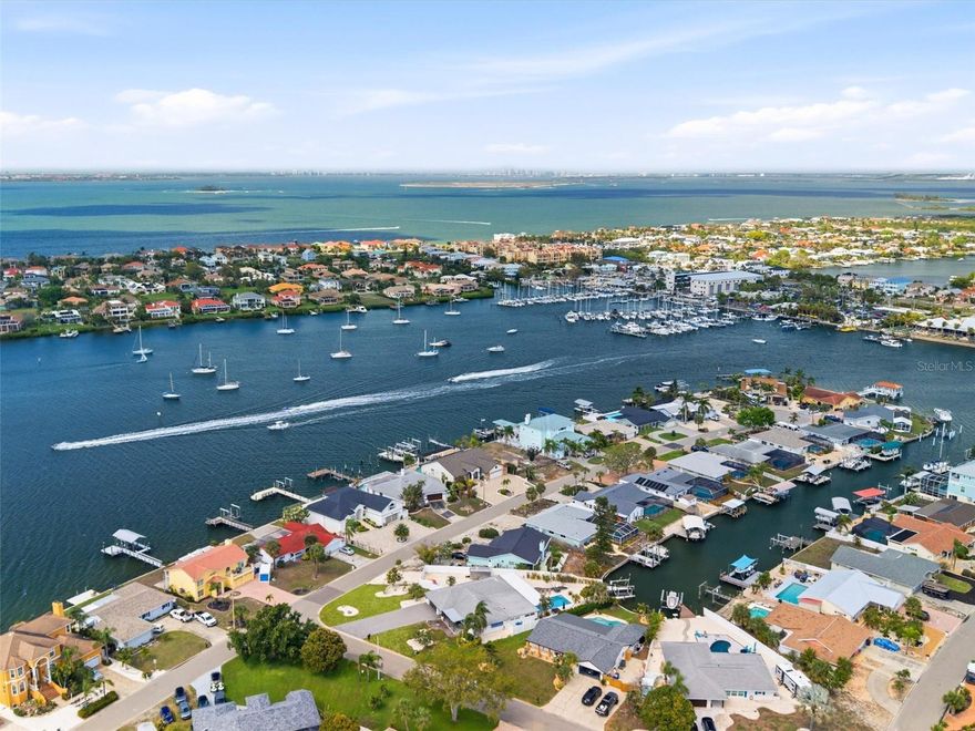 VRBO/Airbnb generating up to $20k monthly sold turnkey! Welcome to an extraordinary, fully furnished waterfront estate—an impeccably curated coastal retreat offering both refined living and exceptional investment potential. Currently performing as a high-yield luxury rental, this residence generates impressive monthly income while providing the perfect sanctuary for a discerning owner seeking a seamless blend of lifestyle and revenue.
Set within the coveted waterfront enclave of Apollo Beach, this single-level masterpiece showcases the pinnacle of modern coastal design. Every detail has been thoughtfully reimagined with the finest materials, creating a sophisticated yet inviting ambiance throughout this four-bedroom, three-bathroom pool home.
Upon entry, wide-plank natural LVP flooring leads you into a stunning open-concept interior anchored by a showstopping chef’s kitchen. Designed for both grand entertaining and everyday luxury, the space features premium Thermador appliances, bespoke solid-wood cabinetry, exquisite quartzite countertops, and dual statement islands, complemented by a fully appointed butler’s pantry.
The expansive floor plan offers a true split-bedroom layout with multiple elegant living spaces, including a custom dry bar overlooking the resort-style pool. The owner’s suite is a private sanctuary, complete with a spa-inspired bath and an extraordinary custom-designed wardrobe. Guest accommodations are equally refined, with three generously sized bedrooms, including a private en-suite, and a beautifully appointed shared bath with dual vanities.
Behind the scenes, the home has been comprehensively upgraded for peace of mind, including full electrical and plumbing replacements, a newer roof, dual HVAC systems, and impact-rated windows—ensuring effortless luxury for years to come.
Outdoors, the property unfolds into a private, resort-caliber oasis. The expansive lot offers rare flexibility for boat and RV storage, enhanced by a limestone drive and gated access. Lush, professionally designed landscaping and privacy fencing evoke the tranquility of a Mediterranean coastal escape, complete with fruit-bearing trees and serene garden spaces.
The covered lanai provides an elegant setting for alfresco living, while a winding path leads to a fire pit and a newly constructed dock with composite decking and upgraded lift systems. From here, enjoy direct boating access to open waters and effortless excursions to iconic destinations such as Beer Can Island, Egmont Key, Passage Key, and Shell Key.
Perfectly positioned on a quiet, private street among other luxury residences, this home offers unobstructed canal views with no rear neighbors—an increasingly rare find. Whether envisioned as a primary residence, a refined vacation retreat, or a continued income-producing property, it delivers unmatched versatility.
Moments away, enjoy local waterfront dining at beloved establishments such as Circles Waterfront Restaurant and Finn's Dockside Bar & Grill, along with easy access to the pristine shoreline of Apollo Beach Nature Preserve, where sweeping sunset views over Tampa Bay create a truly unforgettable backdrop.
This is more than a home—it is a rare coastal offering defined by elegance, privacy, and lifestyle. A one-of-a-kind opportunity to own a private tropical haven where every day feels like a luxury escape.