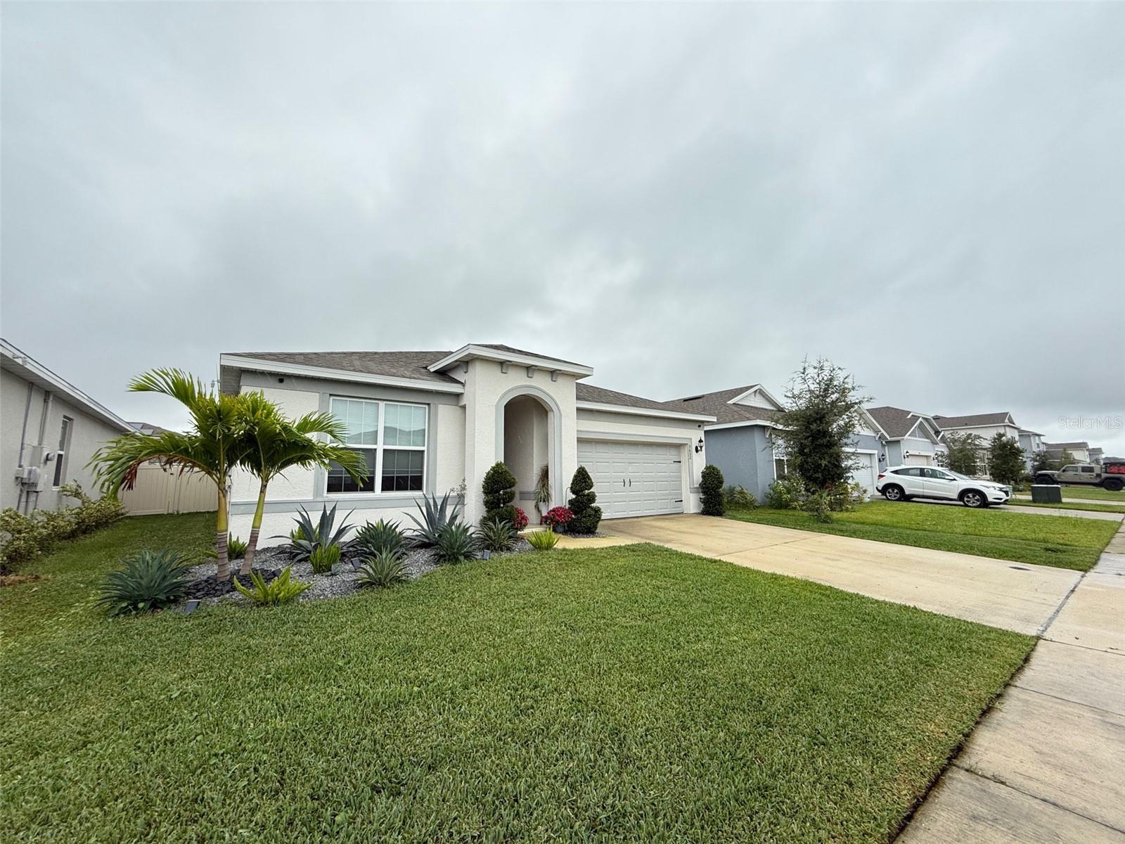 Beautiful one-story home is tastefully designed with a gourmet built-in kitchen, tile throughout the main living areas, and upgraded counters and cabinets, professionally selected by designers, in calming tones. The house also has a sizable covered lanai where you may enjoy the outdoors. This community is close to shopping, dining, and entertainment, and easy commute to Highways 417 and 528, less than two miles from Lake Nona. This subdivision offers community amenities, no CDD, and a low HOA.