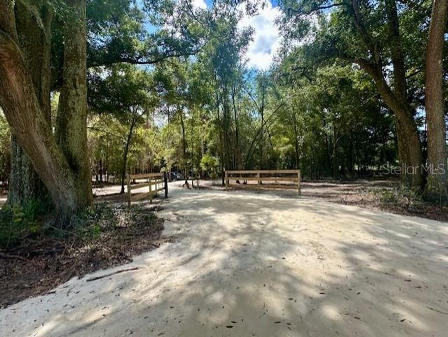 9 BEAUTIFUL ACRES just south of BELL, FL near the Gilcrest Training Center harness racing track. Are you looking for the perfect location to build or place your dream home, start a new homestead or mini-farm, or invest in land with endless potential?! This stunning 9-acre parcel offers just that! Mature oaks and native hardwoods blanket much of the property providing shade, character, and a true sense of privacy. A cleared entrance and established drive make for easy access, and the gated entry adds both convenience and security. A recent survey to be provided. High and dry property! No deed restrictions and no HOA. Come discover what the peaceful country setting is truly like. Located in Gilchrist County with low property taxes and "A" rated schools. Several rivers and freshwater springs nearby. Conveniently situated between Bell and Trenton, with just a short drive to either and within a 30-minutes drive to Newberry, Alachua, or High Springs. Or travel just under an hour to Gainesville or Lake City, perfect for a day trip or to pursue employment or education opportunities. Come see this property for yourself! Conveniently located near the Gilcrest Farms Training Center https://gilcrest-farms-training-center.myfreesites.net/.