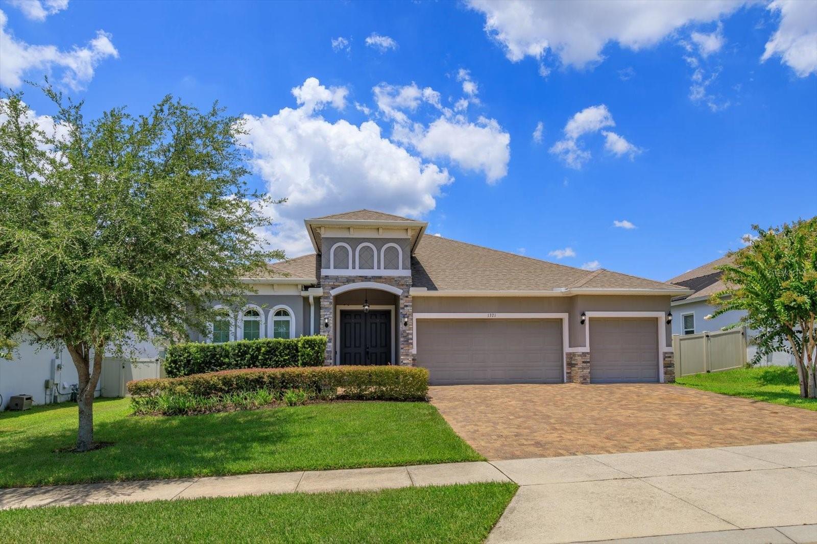 Welcome to 1371 Cavender Creek, situated in the charming Ardmore Reserve Community in Minneola, Florida. This beautifully upgraded RANCH HOME features 4 bedrooms and 3 full bathrooms, thoughtfully designed with both style and practicality, and boasts a three-zone split floor plan, offering excellent privacy and versatility.
The heart of the home is a GOURMET KITCHEN, boasting 42-inch cabinets, an extended GRANITE COUNTERTOP with additional storage, a double oven, a gas cooktop, and a wine refrigerator, which is perfect for hosting guests. Adjacent to the kitchen, the OPEN-CONCEPT LIVING ROOM impresses with a stacked STONE ACCENT WALL and dramatic DOUBLE TRAY CEILINGS. Custom barn doors provide access to a covered lanai and a fully equipped OUTDOOR KITCHEN, which is ideal for enjoying Florida living throughout the year. The 3-car garage has been upgraded with enhanced lighting and premium flooring, offering ample space for storage, hobbies, and other activities.
The spacious primary suite provides a relaxing retreat, complete with its own double tray ceiling and a spa-like ambiance. Throughout the home, details such as SHIPLAP ACCENT WALLS in the foyer and dining area add charm and character.
Additional upgrades include a TANKLESS WATER HEATER, an Aqua Sauna system with a 10-year filter, STONE countertops throughout, laminate flooring in main area, a zip tie roof system, fenced backyard and premium finishes.
Furthermore, the property is conveniently located near top-rated schools, shopping, dining, and major highways, with easy access to downtown Orlando, the airport, and numerous other amenities.