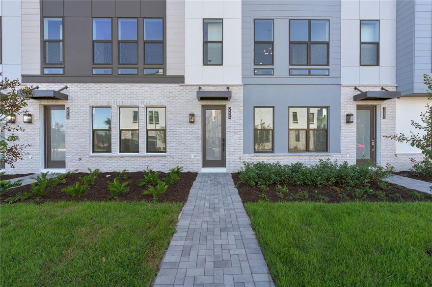 Welcome to The Brix, an exquisite 4-story townhome that lives more like a single-family home, featuring 3 bedrooms and 3.5 bathrooms, plus a stunning rooftop terrace! Enjoy open space park views from the back, offering a rare blend of privacy and natural beauty.

The first floor includes a convenient bedroom and full bathroom, perfect for guests or a home office. On the second floor, the gourmet kitchen is a true showstopper, featuring rich brown cabinetry that extends all the way to the ceiling, sleek white quartz countertops, a fun upgraded backsplash, high-end Whirlpool gas appliances, a spacious center island with breakfast bar, and a walk-in pantry.

The kitchen flows seamlessly into a spacious great room and dining area, creating an ideal layout for entertaining or everyday living. Throughout the home, stylish black hardware fixtures add a modern, cohesive touch. Natural light pours in from every angle, highlighting the home's thoughtful design and picturesque views of the park just beyond your windows.

Upstairs, the third floor hosts a luxurious primary suite with a generous walk-in closet, along with a second bedroom, full bathroom, and a well-placed laundry room.

Capping it all off is the expansive rooftop terrace, prepped for an outdoor kitchen, fireplace, and hot tub—perfect for relaxing or entertaining with stunning panoramic views.

The Brix is perfectly situated within close distance to popular amenities including scenic walking/biking trails, the Orlando Tennis Centre, and the YMCA.

Schedule your private tour today and experience the elevated lifestyle at The Brix!