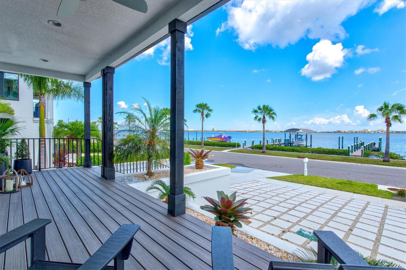 Here’s your chance to own a truly extraordinary waterfront property! This coastal contemporary masterpiece offers panoramic views of the Manatee River and direct boating access to Tampa Bay and the Gulf of Mexico. Built in 2021 by renowned luxury custom builder John Cannon Homes, this residence exudes quality craftsmanship and thoughtful design at every turn. As you step inside, you’ll be captivated by the sense of space, with soaring 18-foot ceilings and an abundance of natural light streaming through hurricane-impact windows and sliders. Every detail has been designed to maximize the stunning water views. For added peace of mind, the home is equipped with a newly installed Generac 24kW partial house generator. Wide plank engineered hardwood floors lend warmth and elegance throughout this four-level home, which also features a convenient elevator. The first level boasts an oversized two-car tandem garage with high ceilings, ample storage space, and sliders leading to the backyard. Ascend to the second level, where the main living area awaits. Here, you’ll find a welcoming front porch, a cozy living room with a gas fireplace, a gourmet kitchen, a dining area, a powder room, and a laundry room.
The chef’s kitchen is a culinary dream, outfitted with top-tier Wolf and Liebherr appliances, quartz countertops, custom cabinetry, two sinks, and a spacious island—perfect for entertaining or preparing meals with ease. The third level features an ensuite bedroom with a private balcony and two additional bedrooms with a shared guest bath. The fourth and final level is dedicated to the luxurious owner’s suite, a private retreat offering a sitting room, steam shower, walk-in closet, and a private balcony. From here, you can enjoy breathtaking river views and stunning sunsets in serene comfort. Step outside into your fenced backyard oasis, designed for relaxation and entertainment. The heated saltwater pool and spa, complete with a sun shelf, invite you to unwind, while the spacious paver deck is perfect for soaking up the sun. Lush tropical landscaping enhances the tranquil ambiance. Boating enthusiasts will appreciate the 80-foot composite dock, ideal for fishing, cruising, or simply enjoying the calming waterscape. You might even spot dolphins playing nearby! This centrally located home is close to downtown, medical facilities, and major roadways like 301 and I-75, making commuting a breeze. The nearby scenic Riverwalk offers dining, entertainment, and play areas, with plans to extend to Manatee Mineral Springs Park. Don’t miss this exceptional opportunity to own a home that perfectly blends luxury, comfort, and breathtaking natural beauty!