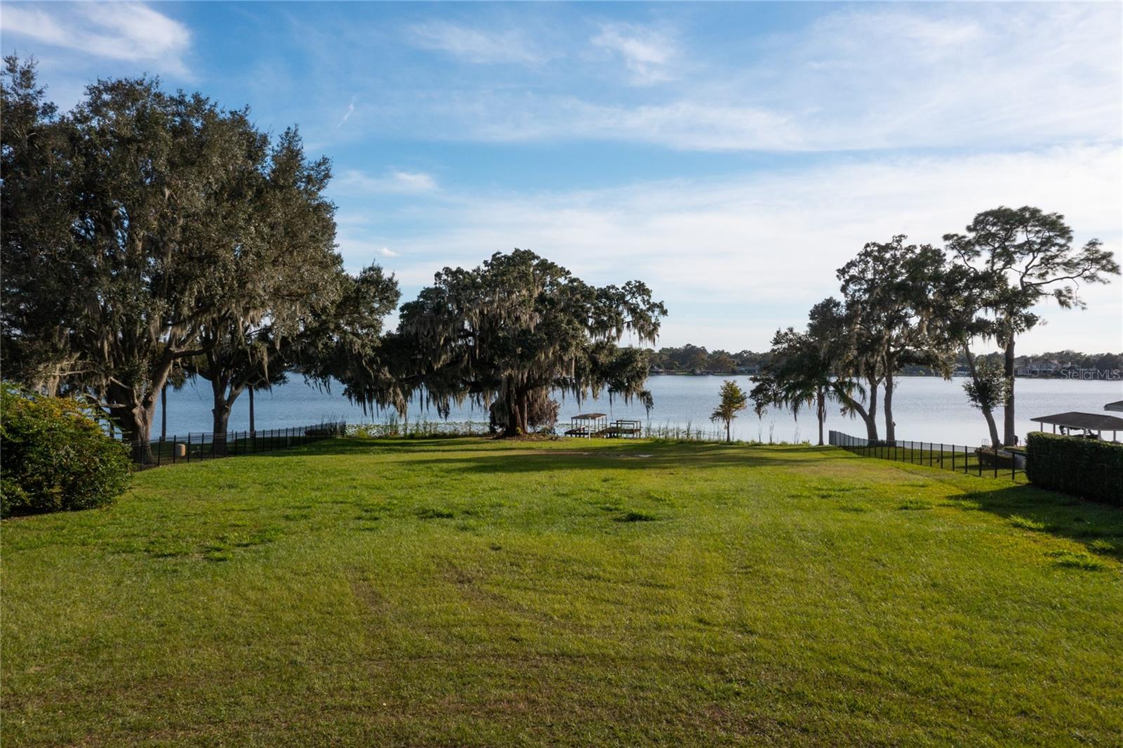 Winter Park chain of lakes, lake front lot. This one-of-a-kind property features 140 feet of frontage on Lake Minnehaha and offers unparalleled panoramic views. This massive lot offers an exceptional canvas for creating a custom, luxury lakefront estate with its own private entry gate and eight-foot privacy wall. With direct access to the pristine waters of the Winter Park Chain, it provides the perfect setting for boating enthusiasts seeking the serene Winter Park waterfront lifestyle for a fraction of the cost. The properties’ unique elevation will even accommodate a three-level estate home with a full walk out basement or partial basement, and an amazing infinity edge pool. Since it faces Southwest, owners are ensured to have spectacular sunsets every night. Located at the end of a quiet street your serene lakefront sanctuary awaits. Don’t miss this incredible opportunity to build the home of your dreams in this exclusive and sought-after location.