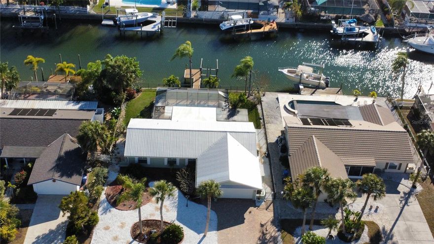 Tranquil waterfront living in this meticulously updated home. The upgrades have been well thought out to ensure a relaxed lifestyle. As you enter, you'll appreciate the open concept with waterproof luxury flooring throughout. Stainless steel appliances compliment the beautiful gray toned granite counter tops. A large stainless sink and soft close drawers are an added bonus in the kitchen. You'll notice the added touches like crown molding, plantation shutters on most window, French doors in master leading to your 16'x32' x 8' deep pool, extra wide pavered driveway for additional parking, and electrical outlets set at 2ft, plus so much more that you're going to want to go see for yourself. 
Hop in your boat and go to lunch at one of the many waterfront restaurants around the Tampa/St Pete area and of course Gasparilla too!!
It's a lifestyle many only dream of.