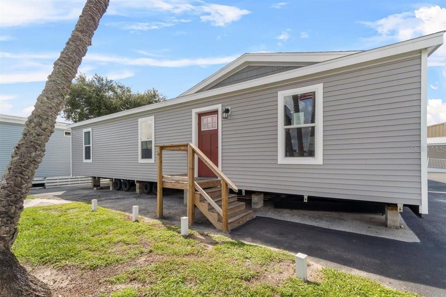 Experience the perfect blend of modern living and natural beauty with this BRAND-NEW manufactured home, situated on your own lot, which is just under a 1/4 acre! Offering 3 bedrooms, 2 bathrooms, and over 1,400 square feet of thoughtfully designed living space. From the moment you arrive, you'll be charmed by the recessed dormer over the front door with vertical vinyl accent, and vinyl door and window trim. Step inside and immediately appreciate the high-quality finishes and attention to detail, from the 4-panel board and batten accent wall or the luxury linoleum flooring throughout, to the open-concept layout that effortlessly connects the living, dining, and kitchen areas-ideal for entertaining. The chef-inspired kitchen is a true highlight, featuring brand-new stainless steel appliances, a sleek chimney range hood, stainless steel sink with a gooseneck faucet, 42" shaker-style cabinets, and canopy-style pendant lighting hanging over the center with a breakfast bar. The primary bedroom offers a serene retreat, complete with a large walk-in closet and a luxurious en-suite bathroom featuring a free-standing soaking garden tub, separate 60" shower, and dual vanities with cubby holes and a bank of drawers-perfect for keeping all your essentials organized. Two additional bedrooms provide comfortable space for family or guests, while the second full bathroom includes a single vanity and a tub/shower combo, perfect for letting guests soak the day away! Additional upgrades include a dedicated laundry room for added convince, LED recessed lighting, Energy Star Certified w/ R- 13 Wall; R-22 Floor, R-38 Roof, cobra ridge venting system with algae-resistant shingles, and craftsman-style trim. Located in the Halfmoon Mini-Farms of Silver Springs, FL, you'll have easy access to a variety of local amenities, including shopping centers and restaurants. This home is at a prime location with no HOA and no lot rent! Don't miss out on this incredible opportunity to make this brand-new home yours! Schedule your viewing today and experience the best of Florida living!