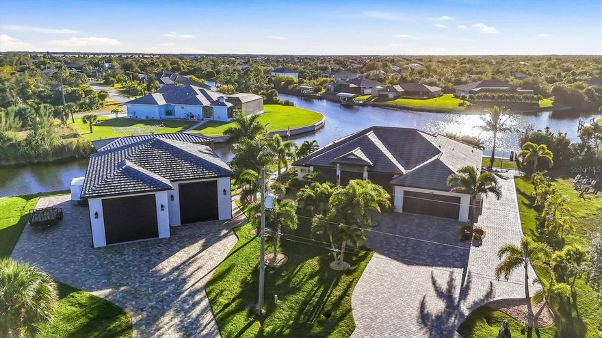 Welcome to this stunning waterfront custom pool home located in the heart of South Gulf Cove - a true boater's dream community with access to the open water. This beautifully designed 3- bedroom, 3 - bathroom home features an open floor plan with elegant tray ceilings and impressive 10 ft. pocket sliding doors that seamlessly blend indoor and outdoor living. A second en-suite bedroom provides comfort and privacy for guests. The gourmet kitchen is equipped with a commercial-grade refrigerator, granite countertops, custom backsplash, wine cooler, and spacious pantry perfect for both everyday living and entertaining. Step outside to your private oasis featuring a heated saltwater pool and spa, surrounded by over 9,000 square feet of pavers and lush, mature landscaping with upgraded St. Augustine grass. The expansive covered lanai includes a full outside kitchen, ideal for enjoying Florida living year-round. Boating enthusiasts will love two private docks with 10,000 - pound boat lifts - one fully covered, ready to go with the click of the remote control - offering open water minutes away. Additional features include: Remote - Controlled electric hurricane screens, Gated property with irrigation system, water treatment system, Detached, air- conditioned RV garage with car lift and four impact garage doors, Whole-home security system accessible via smartphone  and propane generator for peace of mind during power outages. 
This exceptional property offers luxury, functionality, and the ultimate waterfront lifestyle.