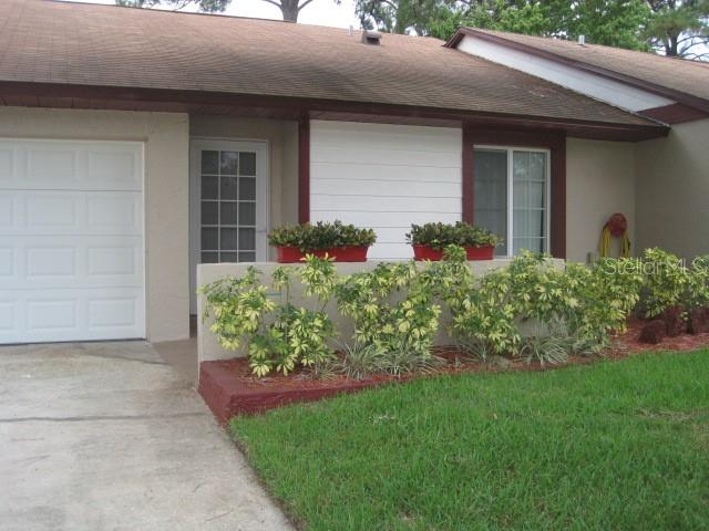 Beautiful 2 Bedroom 2 Bath 2 Car Garage Villa, Extremely Clean and Well Maintained Villa in Hidden Lakes, Spacious 1558 Sq Ft, Open Floor Plan, Kitchen has Glass Top Range with oven, Built in Micro-Wave, Double door Refrigerator with Water/Ice Dispenser, Dishwasher, Solid Counter Tops, Rolling Drawers in Cabinets, Ceramic Tile in all Wet Areas, Open Pass Thru to Formal Dining Room, Double Sink with Garbage Disposal, Large Family Room with Beautiful Laminate Flooring and Sliding Doors to Court Yard that is Wooden Fenced for Privacy, Paddle Fans thru-out, Split Plan, Large Master Bedroom with Laminate Flooring, Large Closet, View of Back Court Yard, Master Bath has Separate Vanity and Walk-in Shower, 2nd Bath has Tub and Shower, Beautiful Cabinets with Marble Counter and Sink, All Up-dated Cabinets, Counters, Paddle Fans, Lighting and Water Fixtures, High Ceilings, Screened Doors to Front and Back, Front Open Patio, Large Oak Tree in Front, Cul-de-Sac, Great Location, Close to Shopping, Restaurants, and Schools. Call Sharon for More Information and Make This One Your Home Today.