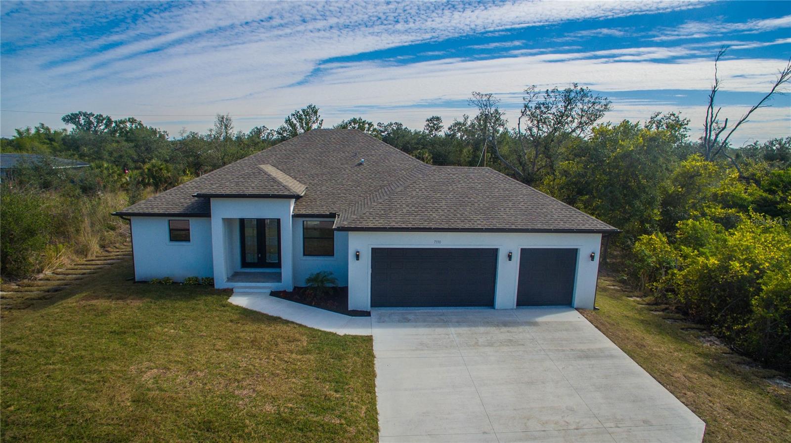 MOVE IN READY! Beautiful 3 bedroom, 2 bath, pool home with a hot tub, flex room and a 3 car garage. This new construction home features
porcelain tile throughout, 9'4 ceilings with ceiling trays in living area and owners bedroom. The kitchen has all wood 42 inch cabinets with crown molding and quartz counters, just off the kitchen the laundry room has additional cabinets for extra storage. Bathrooms also have all wood cabinets and quartz countertops with porcelin tile to the ceiling in both shower and bath area. Sliding doors from living area, kitchen and owners bedroom leads to the large lanai and pool area. The garage holds 3 full size vehicles. Photos are of a previously built home.