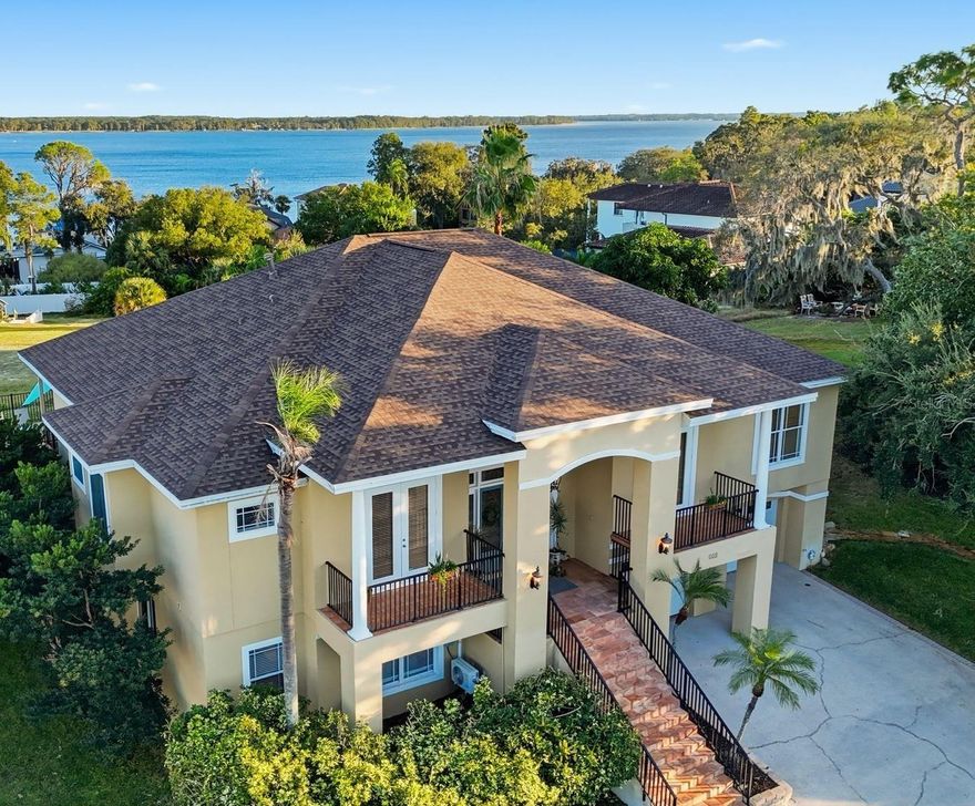 One or more photo(s) has been virtually staged. **Assumable 3.25% VA loan** SELLER CONCESSIONS Availabale. Motivated Seller. Enjoy breathtaking views of Lake Tarpon from this large custom home, perfectly positioned on one of the most elevated lots in the area. This stunning 4 bedroom + den, 4 bathroom, 4,200sqft home sits directly infront of a protected gopher tortoise preserve, ensuring that nothing will ever be built behind you — your serene water views are forever preserved. Prime location! Only 10 minutes from the Sponge Docks and 18 minuts from Fred Howard Park.

Nestled in Waterberry, an intimate, highly sought-after community of only 14 homes on Lake Tarpon, this is one of only a handful of homes that have ever come to market, with only one sale in the past two years. Homes here rarely change hands, making this a rare opportunity to own in one of Tarpon Springs’ most exclusive neighborhoods. Built on a massive hill, high above the floodplain and well beyond Flood Zone X, this home is completely high and dry — it sustained absolutely no storm damage and requires no flood insurance.

Inside, you find plenty of space for the entire family with all four bedrooms featuring ensuite bathrooms! On the main level, you’ll immediately notice the stunning hardwood floors, open-concept layout, high coffered ceilings and water views from nearly every room. The primary suite and main level showcase real hardwood floors, tray ceilings, and elegant finishes throughout. The living room features a beautiful fireplace, crown moldings, and fantastic views of Lake Tarpon. Just off the living room is the kitchen, complete with wood cabinetry, granite countertops, newer stainless steel KitchenAid appliances, and a spacious eat-in area perfect for breakfast. The formal dining room off the kitchen is ideal for larger gatherings and celebrations. On the opposite side of the living room, French doors open to a versatile den, perfect for a home office with its own private balcony. The lower level (or basement) has been fully permitted and thoughtfully finished to include over 1,300sqft of living space, including a private 4th bedroom or in-law suite, a game room, plus plumbing for a wet bar or kitchen — ideal for guests, multi-generational living, or entertaining. You’ll also find a dedicated wine cellar for your collection.

Relax in style on your large covered porch overlooking the pool and lake. Step outside to your private paradise and enjoy a resort-style saltwater pool with water features, firepit, and a raised patio perfect for nighttime entertaining — all while taking in tranquil water views of Lake Tarpon from the pool deck. The 0.28-acre (12,589 sq ft) lot offers generous outdoor space and an oversized 4-car garage with plenty of room for a boat or extra storage.

Recent upgrades provide complete peace of mind and modern comfort, including a new roof (2022), a new central HVAC system (2022), with a new mini-split for the lower level added in 2023, and remodeled primary bathroom and remodeled guest bathrooms (2023). This home features a new hot-water heater (2022), electronic and manual roller shades throughout (2022), and a newer Maytag washer and dryer (2020). A propane tank added in 2021 provides convenient gas service with easy, once-a-year fill-ups.

Aggressively priced below comparable homes, this Lake Tarpon gem combines serenity, luxury updates, and unmatched elevation — all with no flood insurance required, low HOA costs, and no CDD fees.