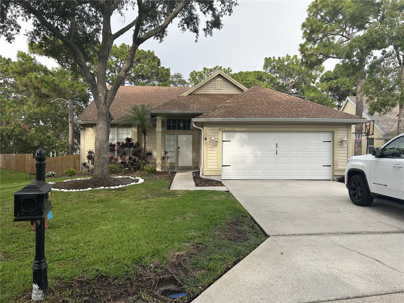 This incredible and lovingly cared for 3 bedroom, 2 bath, 2 car garage home, is located in the much sought after Enclaves at Gleneagles in Palm Harbor! New roof installation starting on September 4th. This move-in ready home is a must see! Updates include a deluxe master bath remodel, and luxury vinyl floors and plantation shutters installed in the main living areas. This home is so well decorated that you have to wonder if Martha Stewart had her hand in it! There are Top rated Schools, and for those that like to often like to hit the Greens, you are a stones throw from Innisbrook Resort and Golf Club! This home rests on one of the bigger lots in the subdivision and could easily accomodate an inground pool, with plenty of room to spare! The second bedroom can be accessed through the Primary Bedroom or hallway, which is a perfect set-up for a nursury. There is an screen enclosed backporch, which leads to an open deck that overlooks your large backyard, with stairs leading you down to your spacious fenced backyard area! The indoor laundry room is off of the 2 car garage, complete with the outlet needed to install an EV Charger. Grab your favorite agent for a showing before this beauty gets away!