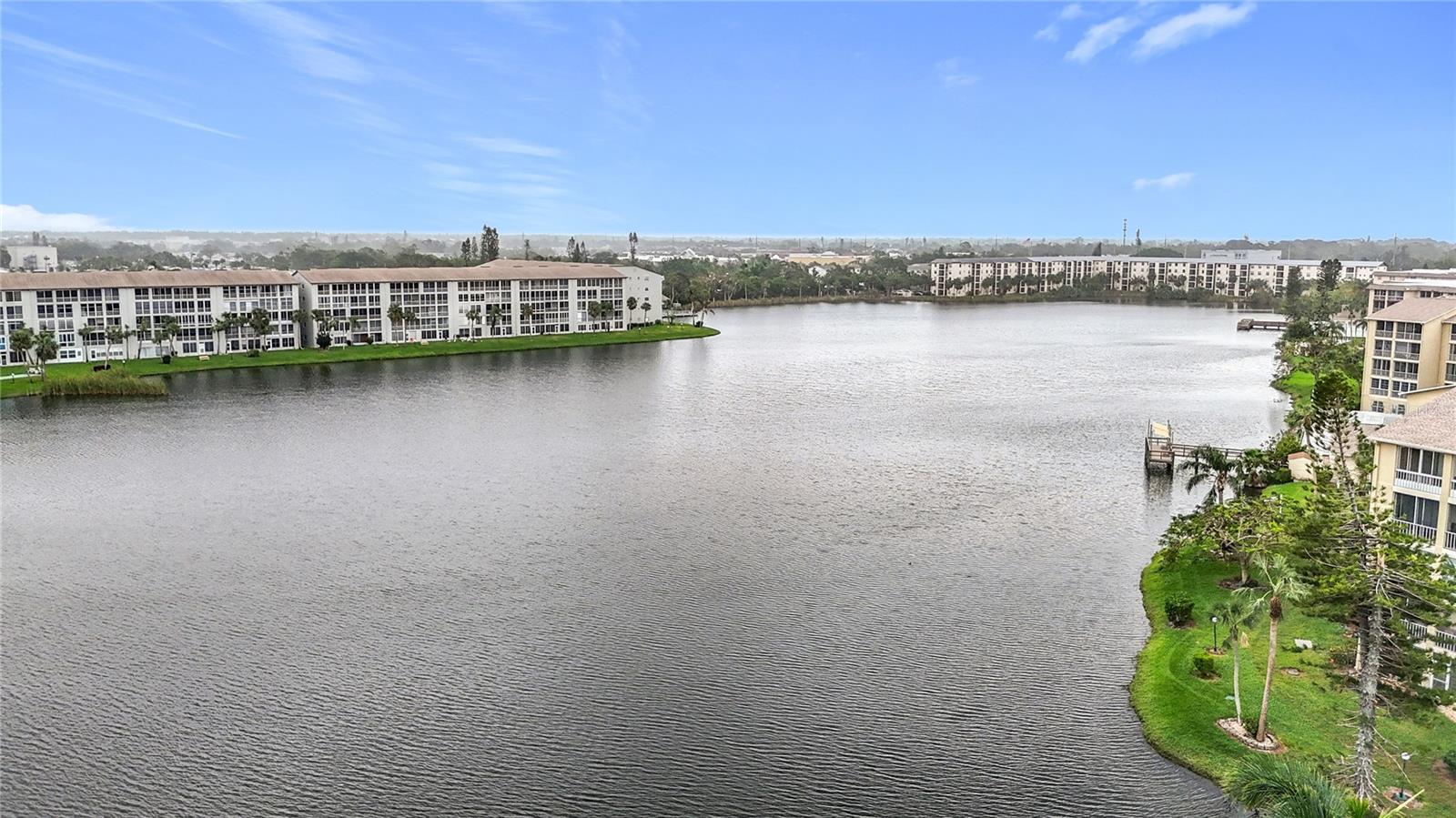 FULLY FURNISHED!! This condo exceeds expectations! New, New, New, and View, View, View! 1st FLOOR! LAKEVIEWS!! 2 bedrooms, 2 bathrooms WITH LAUNDRY! KING SIZE BED IN PRIMARY BEDROOM!! Assigned parking just a few steps from your front door! NEW luxury vinyl flooring in kitchen, dining, living and bedrooms in 2023! NEW stainless-steel appliances in 2023, and a NEW water heater in 2024. Don't like popcorn ceilings, then this condo is one to call home. This updated condo comes furnished!!! Like to fish? Don't miss out on the fishing pier and benches around this gigantic lake! Don't forget to take a dip in the heated pool. Fantastic lake view right from your lanai. The designer decor is absolutely beautiful! Conveniently located just eight miles to the beach and minutes from shopping and dining. This condo is a cute as the community. 55+ Make your private showing today!