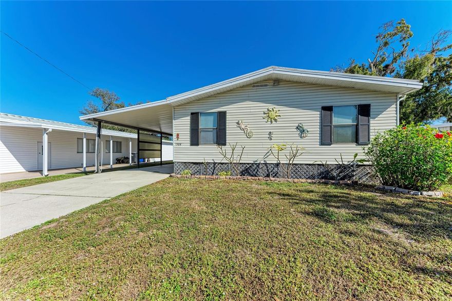 Retirement at its finest! This manufactured home in the 55+ community Tidevue Estates is one of the largest in the community.   There is plenty of space for you to call home. Bring your personal touches to make it your own.  As you enter the home from the carport, you will instantly notice the indoor laundry space with plenty of cabinets for extra storage. If you enjoy cooking, you'll love this spacious kitchen with an island for extra prep space and lots of storage room.  This home has a dining room large enough to fit a full size dining set.  The primary bedroom has 2 separate walk-in closets and an ensuite bathroom with full vanity, standing shower, and private water closet. The second bedroom also has an ensuite bathroom that connects back to the laundry/entry area. The living room opens up to the spacious Florida room that looks out over the lake. Or, you can close the decorative doors to Florida room and make it a separate room or office space. Proceed from the Florida room to the screened lanai to enjoy the cool evening breeze or enjoy a cup of coffee or tea from the bench swing in the backyard as you gaze out over the lake streaming with wildlife.  Bring your canoe or kayak as well, you can launch right from the wooden dock on your property. Don't be afraid that you won't have enough storage space here. There is a large room (18' x 13') that you can use for storage, workshopping or crafting.  The possibilities for a peaceful retirement are endless in this beautiful home. Plenty of activities will keep you busy in this community. The community pool is solar-heated for year-round enjoyment. The community library has free WI-FI connection. Recently updated fitness center. Other activities you may find here are indoor pickleball, bocce ball, or shuffleboard. Near many parks, restaurants, and shopping. Easy access to I-75. Tidevue Estates is a land-owned park so no lot rent. It is also a pet-free park, however the HOA makes allowances for properly documented ESA pets. See documents for additional information.