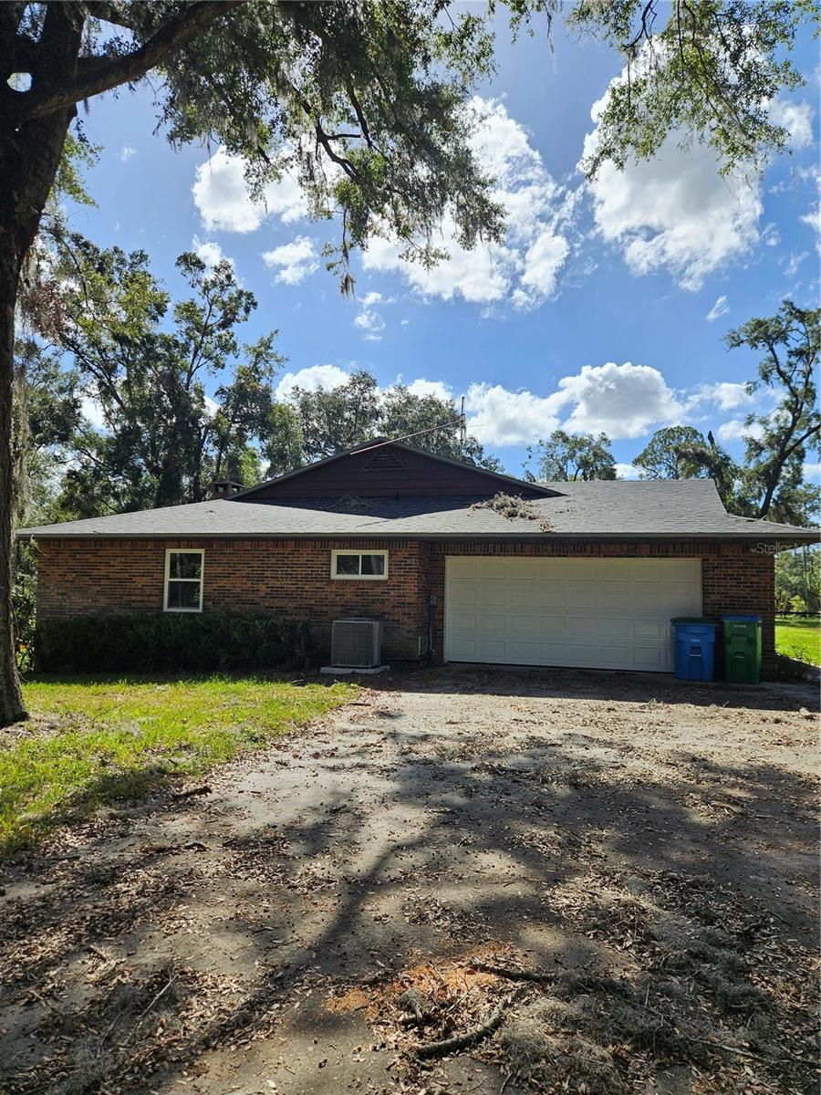 This property was purchased out of a County Auction. Since purchasing the owner has put on a brand new roof (shingle tiles), a new AC, and new windows. The roof and windows were fully permitted and approved by the City of High Springs. The interior of the house needs cleaning, painting, minor drywall repair, new kitchen and at lease one new bathroom vanity are in a not-so-pretty state. This 3 bed 2 bath on the top of High Springs highest hill features a two car garage and a separate mother-in law efficiency suite with a screened in front sitting area. There is also a built up fireplace /grilling station. The property represents an opportunity for a handy owner to create equity.