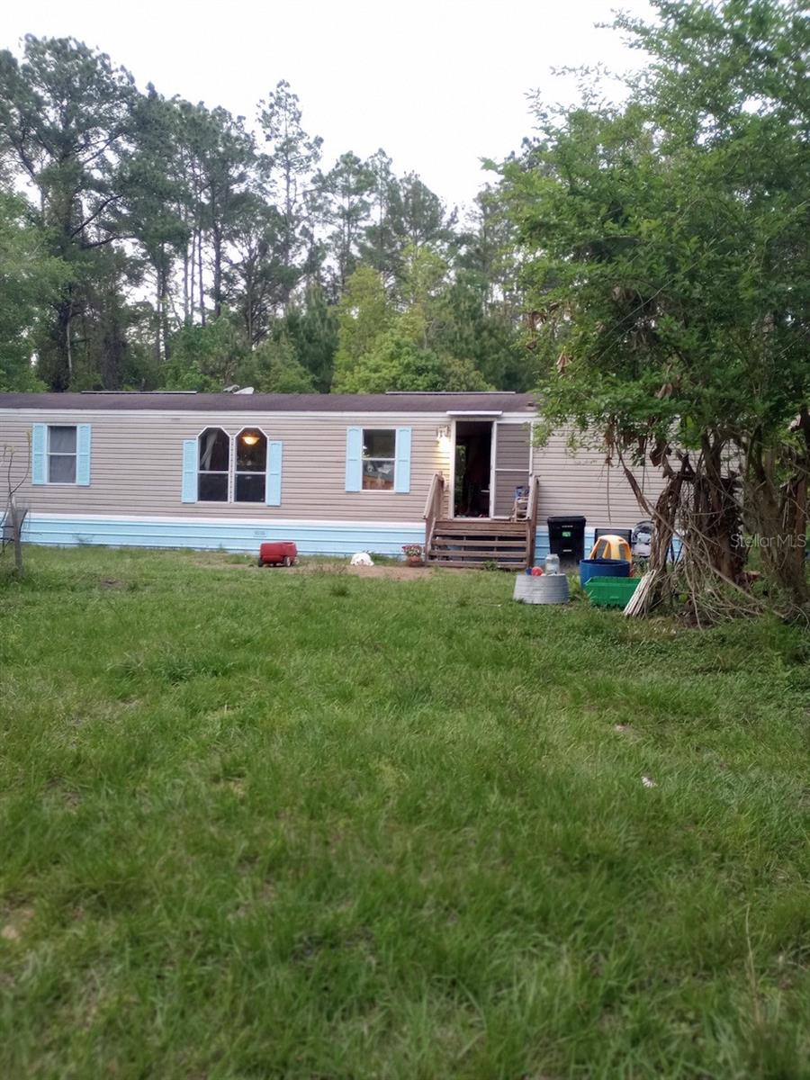5 acre homestead featuring a remodeled 2 bedroom 2 bath single wide in a fantastic location just minutes outside Melrose. Tile, wood and laminate flooring throughout.Â
Established food and medicinal plant forest where mulberry, fig, pear, banana, elderberry, camphor, grape, citrus, turmeric, galangal ginger, sweet potato, pumpkin and more can be found. Additionally, various animal shelters, fencing, and a 250 gallon rainwater catchment system support your homesteading endeavors.Â
The insulated and air conditioned studio cabin is suitable for Airbnb, additional housing, or home office. The additional large shed provides space for your tools and equipment.