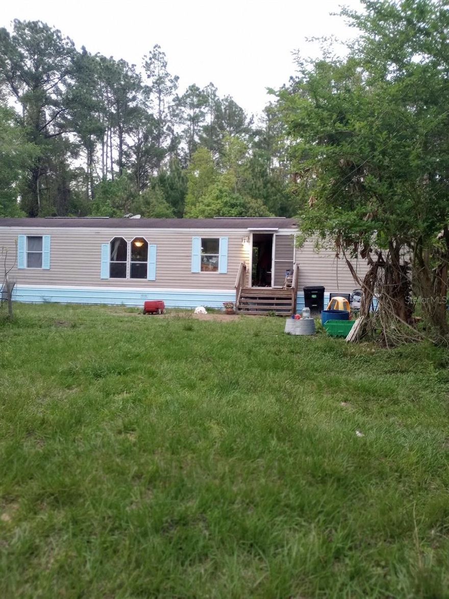 5 acre homestead featuring a remodeled 2 bedroom 2 bath single wide in a fantastic location just minutes outside Melrose. Tile, wood and laminate flooring throughout. 

Established food and medicinal plant forest where mulberry, fig, pear, banana, elderberry, camphor, grape, citrus, turmeric, galangal ginger, sweet potato, pumpkin and more can be found. Additionally, various animal shelters, fencing, and a 250 gallon rainwater catchment system support your homesteading endeavors. 

The insulated and air conditioned studio cabin is suitable for Airbnb, additional housing, or home office. The additional large shed provides space for your tools and equipment.