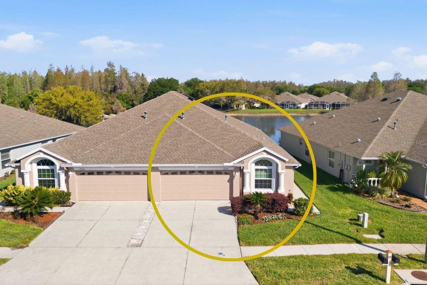 Welcome to maintenance-free living in the sought-after gated section of Oakstead. This beautifully maintained 2 bedroom, plus den, 2 bath, 2-car garage villa offers over 1,700 sq ft and sits on a peaceful pond-view homesite. The open floor plan features a gourmet kitchen with abundant cabinetry and counter space, stainless steel appliances, and a gas cooktop overlooking the dining area and family room. Sliding glass doors lead to a screened lanai with tranquil pond views, perfect for relaxing at the end of the day. The primary suite includes a walk-in closet, dual vanities, and an oversized walk-in shower, while the guest bedroom and bath are located at the front of the home for privacy. Enjoy true maintenance-free living with a low HOA fee covering the roof, exterior paint, lawn care, and irrigation. Recent updates include a new roof (2023 – HOA responsibility), Carrier A/C (2023), new windows and sliding glass door (2016), and newer appliances. Oakstead offers resort-style amenities including a clubhouse, pool, fitness center, playground, tennis courts, scenic walking trails, and a full calendar of community activities. Conveniently located near SR-54 and the Suncoast Parkway with easy access to shopping, dining, and Tampa. Schedule your private showing today.