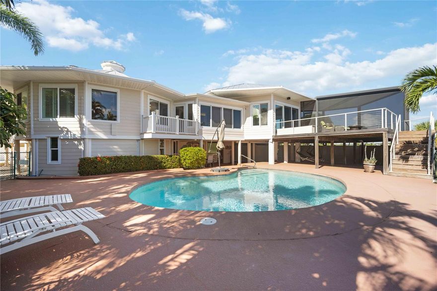 One or more photo(s) has been virtually staged. Welcome to your slice of paradise on Manasota Key! This stunning waterfront residence boasts an exceptional location on Lemon Bay with deeded access to a private Gulf of Mexico beach, providing an unparalleled coastal lifestyle. Situated on nearly an acre of land, this exquisite property offers an awe-inspiring open floor plan that showcases breathtaking 180-degree views of Lemon Bay.
Immerse yourself in the beauty of this uniquely designed architectural masterpiece, fully renovated in 2014 to embody both elegance and resilience. Designed for safety and serenity, the home is elevated on pylons to safeguard against storms. Upgraded with hurricane impact windows and doors throughout, including the garage, along with a durable metal roof, this home ensures both style and safety. A 3-car garage provides ample space for your vehicles and storage needs. Additionally, a portable generator provides peace of mind during any unforeseen circumstances.
The main living level epitomizes luxury living with 3 bedrooms and 2 bathrooms, complemented by a seamless open-concept layout. Entertain effortlessly in the formal dining room or cozy breakfast nook. The home features a cocktail bar complete with a Kegerator for pouring your favorite draft beers. The gourmet kitchen, adorned with Rain Forest Green Marble countertops and an island with seating for two, is a chef's delight. The expansive living room offers a serene ambiance to relax and relish the panoramic vistas of Lemon Bay.
Step outside to discover a resort-style experience with a gorgeous pool, sun deck, and a covered, screened-in porch featuring a louvered roof, perfect for embracing the Florida lifestyle.
The ground level is a haven for outdoor entertainment, offering two swing chairs, dining areas, an outdoor shower, and a convenient half bathroom. Abundant storage space on the ground level ensures effortless organization of outdoor essentials.
For water enthusiasts, a private dock equipped with a covered boat lift (7000lb lift capacity), power, and water access awaits you for your boating adventures.
Nearby, the Private Manasota Key Beach club awaits, offering tennis, dining, and stunning sunset views for your enjoyment.
This stunning home is being sold partially furnished, allowing you to effortlessly transition into coastal living. 
Don't miss this exceptional opportunity to own a luxurious retreat nestled in the beauty of Manasota Key, offering unparalleled waterfront living and remarkable amenities.