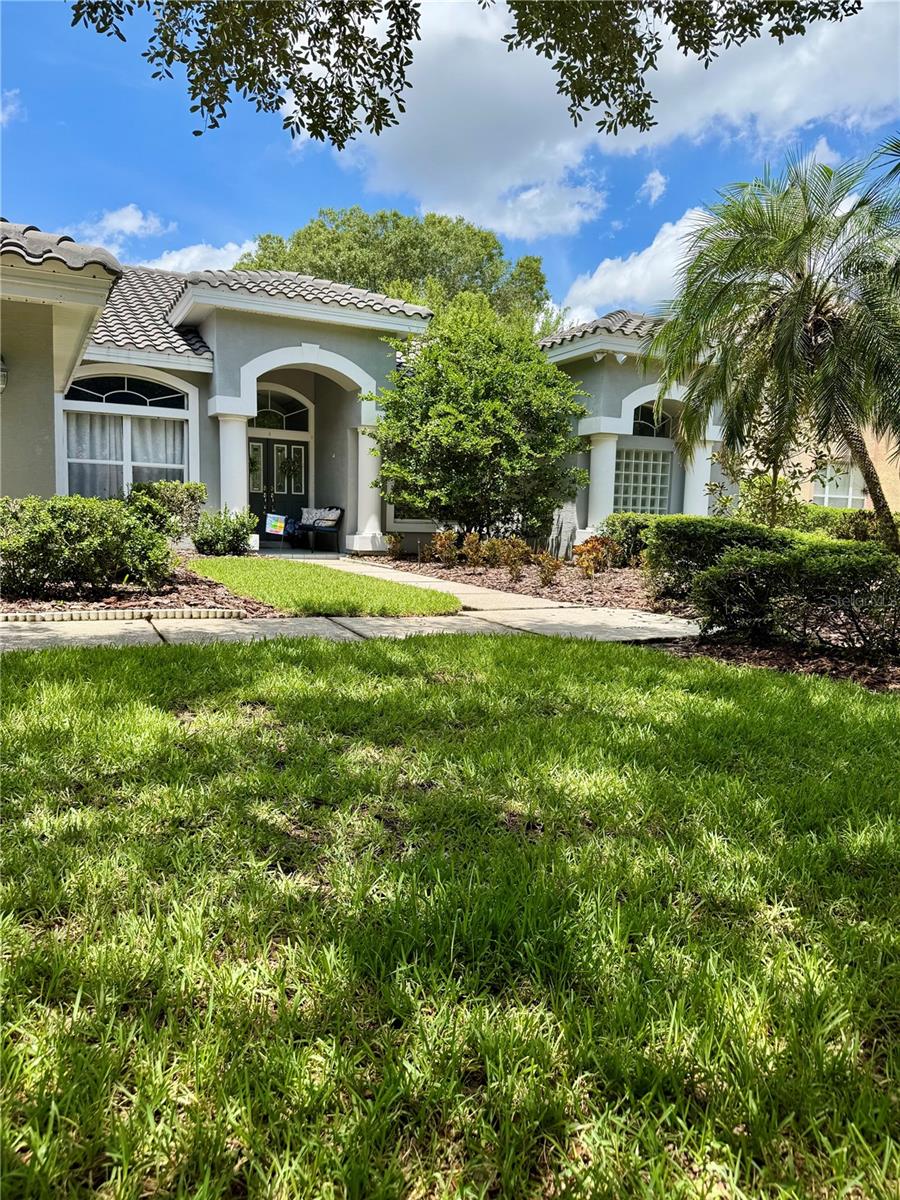 Welcome to this bright and inviting 5-bedroom, 3-bath, and 3-car garage home set on a quiet cul-de-sac street within the exclusive double-gated community of Hunters Green. Freshly painted, well-maintained, and lovingly cared for, this home is ready to be passed on to its next proud homeowner. Soaring ceilings, abundant windows, and an open layout fill the space with natural light and a warm, welcoming ambiance. The spacious kitchen overlooks the living room and offers an island, breakfast nook, and ample counter space for the home chef. Step outside to an oversized screened pool and large covered lanai with serene conservation and golf course views, offering both beauty and privacy. Hunter's Green provides resort-style amenities including a championship golf course, country club, playgrounds, tennis courts, picnic areas, and miles of sidewalks perfect for walking, jogging, or biking. This peaceful, safe neighborhood blends long-term residents with young families, and offers quick access to I-75, shopping, dining, and downtown Tampa, close to Pinellas beaches and about 50 miles to Orlando's theme parks. American Home Shield Home Warranty is offered to the new homeowners!
