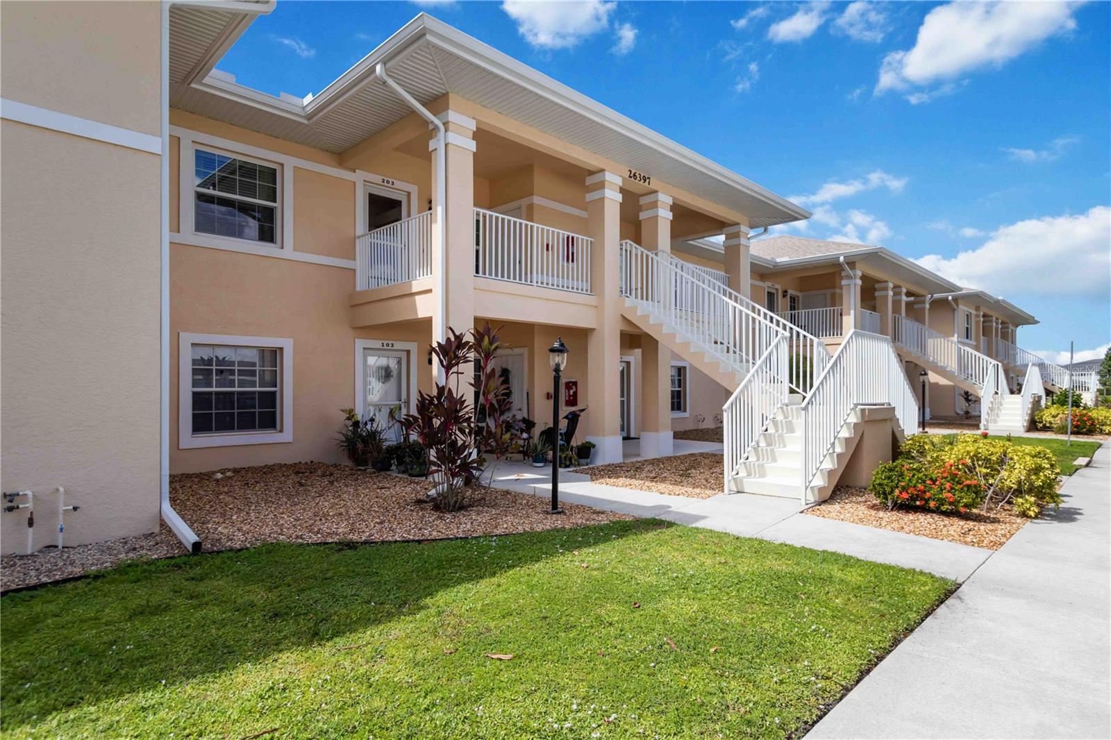 Gorgeous second-floor Deep Creek condo boasting stunning views of tranquil Lake Rio! A welcoming front porch offers the perfect spot to savor your morning coffee while enjoying Florida’s beautiful weather. Step inside to an inviting foyer that opens into a spacious, open-concept home. The kitchen features newly remodeled counters, backsplash, and additional cabinetry, wine fridge, and counter space. Home also features recessed lighting, and a living room with expansive breathtaking lake views. The combined living and dining room impresses with vaulted ceilings, wood laminate floors, and sliding glass doors that lead to the screened-in lanai, flooding the home with natural light. The primary suite offers serene lake views, a walk-in closet plus a second closet for extra storage, and an en-suite bathroom with a tiled shower and separate linen closet. The private guest quarters include a comfortable bedroom and full bath, ensuring visitors feel right at home. Sliding glass doors lead to the screened lanai, where you can enjoy spectacular lake sunrise and sunset views—ideal for outdoor dining. Additional features include an interior laundry closet, outdoor storage closet, covered assigned parking, and a community pool just steps from your lanai. Situated on a quiet road across from Deep Creek Golf Club, this condo offers low-maintenance living with monthly fees covering exterior building and grounds maintenance, insurance, and pool care. Perfectly located near I-75, restaurants, shopping, boating, and all the amenities of the deed-restricted Deep Creek community, and just minutes from downtown historic Punta Gorda, Sunseeker Resort, and beautiful waterfront parks. This lakefront retreat is ready for you to enjoy the best of the Florida lifestyle!