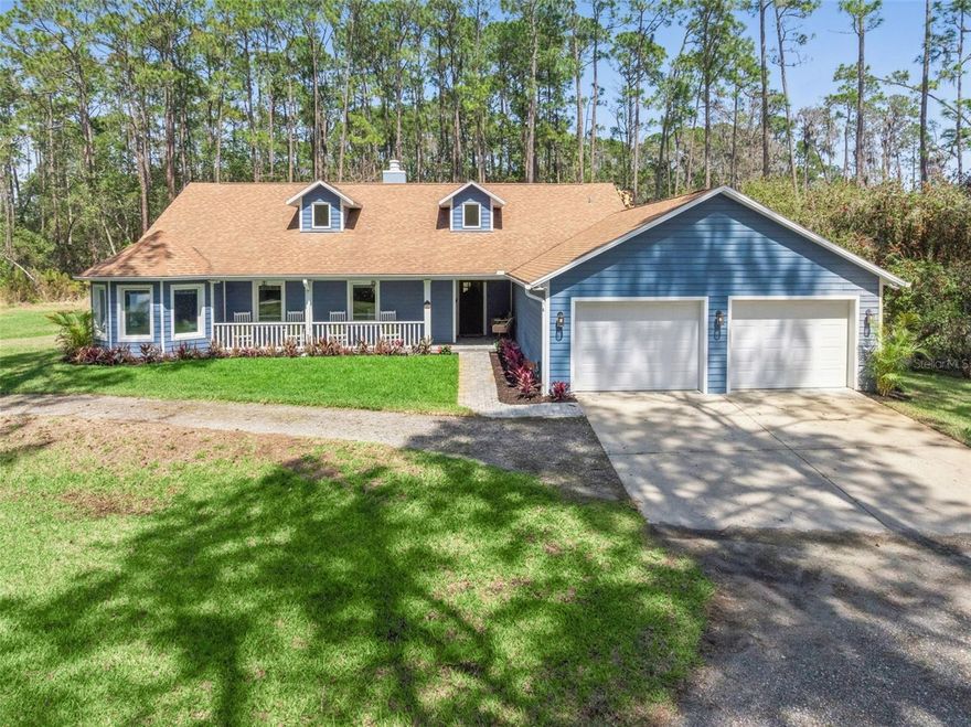 Tucked away on a peaceful dirt road, this fully renovated single-story retreat offers the best of both worlds—privacy and convenience—set on a sprawling 5-acre lot with no HOA. The property includes two adjacent 2.5-acre parcels being sold together, creating a rare opportunity for expanded space, flexibility, and future potential. Originally custom-built with distinctive character and thoughtfully enhanced with recent updates that elevate both style and functionality, the home showcases 8” wood-look Shaw tile flooring, crisp white cabinetry, Calacatta quartz countertops, subway tile backsplash and shower surrounds, shiplap and barn door accents, custom lighting, and upgraded fixtures throughout—creating a seamless blend of charm and modern sophistication. Cathedral ceilings with attractive wood beams add warmth and architectural interest, enhancing the open and airy feel of the home. The open-concept kitchen, dining, and great room are designed for gathering, complete with a double-sided fireplace, an oversized island, and a coffee bar. Start your mornings in the charming dinette, sipping coffee while wildlife wanders by. This thoughtfully designed home includes two primary suites, a dedicated home office, spacious closets throughout, an oversized mudroom with a dog shower, and an extended-bay workshop garage. Step outside to your year-round oasis—cool off poolside in the summer or unwind in the heated spa on crisp winter nights. With 5 acres of land, there’s ample room for horses, farm animals, recreational toys, gardens, or simply space to breathe. Ideal as a primary residence, secondary home, or investment opportunity, this property also offers excellent potential with the option to subdivide the lot. All appliances, water softener, and whole-home generator convey, with furnishings available separately. Owner relocating—quick move-in available. Enjoy the perfect blend of peaceful country living while being just minutes from the beaches, dining, and shopping of New Smyrna Beach, with convenient access to the greater Central Florida area!