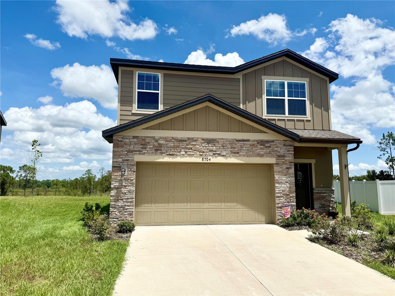 Welcome to your dream home in the highly sought-after community of Phillip Landings in Groveland, FL! This stunning two-story, built in 2024, was designed with modern living in mind. Step inside to discover an open and inviting floor plan, where the first floor and staircase are finished with luxury vinyl plank flooring, combining durability with elegant style. Every detail has been thoughtfully included; this home comes fully equipped with all appliances and window blinds throughout, so it’s truly move-in ready. The heart of the home features a sleek, perfect for family gatherings or hosting friends. Upstairs, generous bedrooms and a private owner’s suite create a peaceful retreat. The real showstopper is the expansive backyard on a .18-acre homesite; a rare find offering endless possibilities.