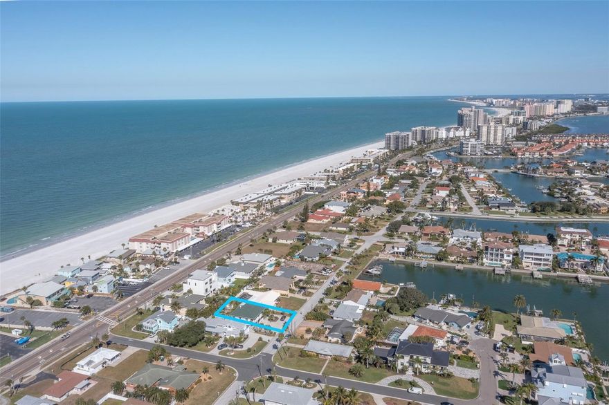 One or more photo(s) has been virtually staged. What if you could feel like you live in Europe, yet still be just moments from the tranquil caress of the Gulf and the white-sand beaches of Belleair Beach's exclusive, private community? Welcome to a unique coastal estate that blends timeless Mediterranean charm with the relaxed luxury of West Coast Florida living. Designed for both easy, private living and effortless entertaining, this home offers space for everyone -- from quiet mornings with coffee in the salt-kissed breeze to evenings filled with laughter from the kids and grandkids. The beautifully appointed kitchen features a waterfall island bar with a built-in wine fridge, perfect for gathering and creating memories over a slow weekend breakfast. Throughout the home, you'll find refined finishes including LED mirrors, floating vanities, sleek fixtures, and stunning European-inspired tilework. A central vac system adds comfort and practicality, while the separate laundry room, expansive storage, and generous garage make daily life seamless. Two large balconies offer serene outdoor living, and the spacious first level provides exceptional flexibility -- ideal for a man-cave, hobby room, craft studio, workout space, golf simulator, or anything your lifestyle calls for (within building codes). Step outside to a backyard that feels like your own private retreat. Already adorned with palms, fruit trees, and an impressive pergola, it strikes a perfect balance of shade and sunlight -- an inviting canvas ready for your dream outdoor oasis. With abundant parking, unique architectural character, and endless potential, this Belleair Beach gem truly brings Europe to the Gulf Coast. All that's left is for you and yours to make it your new beachside sanctuary.