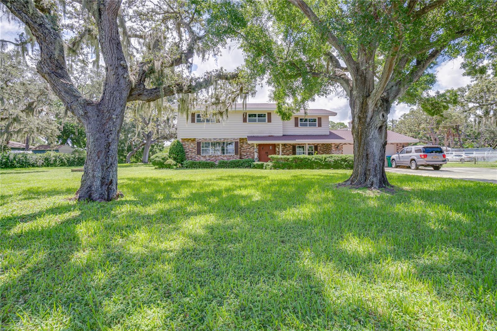 Is your family tired of looking for that perfect place to call home? This estate is exactly what you’ve been looking for, offering a rare combination of land (a full acre), abundant storage (five garage spaces), a tranquil waterfront setting, income potential (with an ADU), and a refreshing pool – all ideally situated in the heart of Pinellas County, Florida. Enjoy incredible convenience with Target less than 5 minutes away, beautiful beaches just a 10-minute drive, and downtown accessible in under 20 minutes. While this cherished family home at 6625 Burning Tree awaits your personal touch and updates, envision the masterpiece. The property features a main house with 4 beds/2.5 baths and a 2-car garage spanning 2,701 sqft (new roof in 2020 and updated HVAC units), plus a separate 888 sqft second residence with 1 bed/1.5 baths, a full kitchen, living, and dining room, all perched above a 3-car garage overlooking the Bayou. Importantly, unlike other waterfront properties neither structure sustained interior flooding during recent storms, offering peace of mind. Given its unique features, this property will attract diverse buyers, and the sellers, understanding that this is truly a generation home ready for its next owners, are enthusiastically open to receiving your proposal. Schedule your showing, submit your terms, and start living in your new home!
Lender Credit of 1 percent with use of our preferred lender!