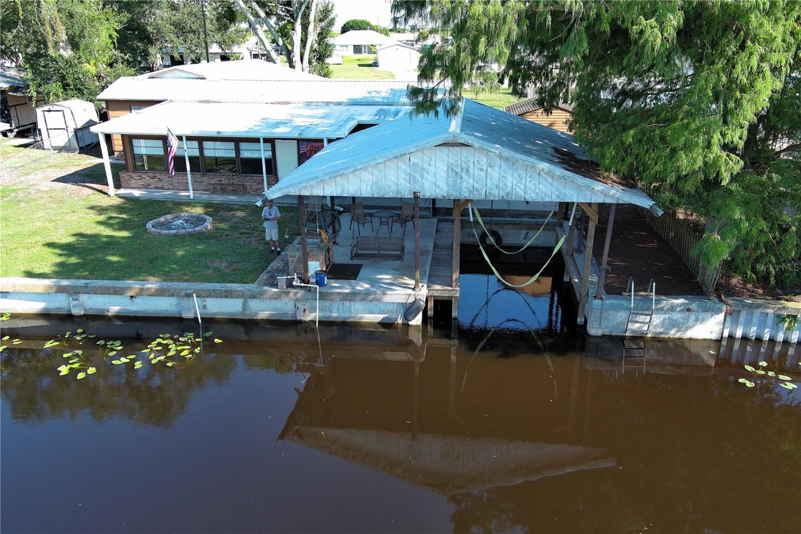 Big Beautiful Brick & Cedar canal front home on .30 acres! Irresistible interior floorplan. Ideal location closest to the lock on Lake Okeechobee. Large front yard with double Covered Carport. New Boat Lift w/Slip for a 21' Pontoon or Bass Boat. Stong Seawall. You will appreciate the convenience of RV parking w/full hookups. Newer Roof, AC and HWT. Solid 10'x12' Shed w/ramp. Perfectly located Firepit. A large Propane Tank fuels Range and Outdoor Grill. The 28'x16' Great Room overlooks the water. Located in Buckhead Ridge, it's the perfect place to call home!