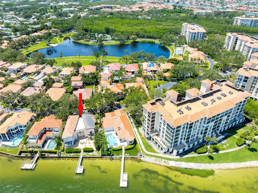 Welcome to paradise, this beautiful home was HIGH and DRY with NO water intrusion from last year’s storms!  Enjoy waterfront living at its finest in this spectacular coastal inspired oasis. This magnificent home is located in the 24 hour guard gated waterfront community of Dolphin Cay which offers tennis courts, two heated swimming pools (one of which overlooks the private 2 acre beach on Boca Ciega Bay), community center with billiard room, library, fitness center and lushly landscaped walking trails. Upon entering the home you'll notice the spacious open floor plan with travertine floors, 22 ft high ceilings, and an abundance of windows that are all designed to take advantage of amazing water views from almost every room. This home offers 4 bedrooms 3.5 bathrooms, a popular split floor plan and an oversized 2 car garage with an additional enclosed storage area perfect for kayaks, paddle boards, etc. Upon entering you will be greeted by the expansive water views from the generously sized living room which opens to the dining room and beautiful kitchen. The kitchen has a breakfast nook and a large island for additional seating and electric, sink, dishwasher and separate ice maker. It features granite counters, wood cabinets with under cabinet lighting, built-in oven, microwave, warming drawer, 6 burner gas cooktop, subzero refrigerator, vegetable sink and closet pantry. The laundry room offers additional cabinetry, sink, and laundry chute for convenience. The large dining room is separate, off the family room, and leads to the tastefully remodeled half bath and separate office with built-in bookshelves and gas fireplace. There is also a lower level bonus room off the living room (not included in the square footage) that gives you an additional space for a home gym, media room, 5th bedroom, etc…the possibilities are endless. From the living room, there is a staircase that leads to the Primary suite with wood-plank ceramic tile floors. The large bedroom offers expansive water views and has a Juliet balcony. The large walk-in closet offers built-in storage stystemand the huge luxurious marble bathroom features dual vanities, separate tub, and oversized shower with body jets. On the opposite side of the home are three additional bedrooms, one with it’s own private balcony overlooking the water and two upscale and remodeled bathrooms. One bathroom features a walk in shower with frameless glass, and the other large bathroom has a shower/tub combination, both with high-end finishes. Outside there is a tiered tile patio that’s stubbed with gas for an outdoor kitchen and has an electric retractable awning with LED lights to provide shade, which is perfect for entertaining, and overlooks your private composite dock with water and electric. Located just inside the no-wake zone, you are in protected water with breathtaking views.  Other features to note, the home has double paned windows and hurricane shutters, newer a/c (2021) units, and gas tankless hot water heater. Steps away from the community pools and several electric vehicle charging stations, the home is conveniently located ten minutes from Gulf Beaches, Fort De Soto Park, all the great venues in downtown St Petersburg and just 30 minutes to Tampa Int'l Airport. Make your private appointment to see this gem today!
