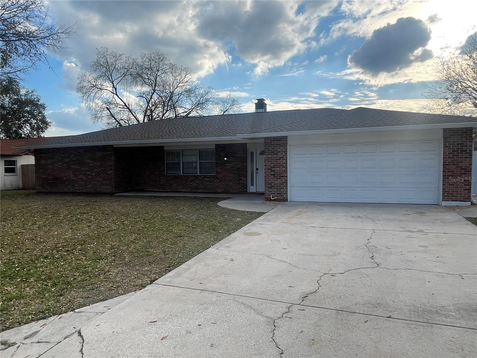 HUGE BACKYARD! COMPLETELY REMODELED! Need space, look no further. Come check out this 3-bedroom 2 bath home with oversized 2 car garage. (21 x 24). This home has been remodeled top to bottom to include NEWER KITCHEN with QUARTZ countertops and NEWER STAINLESS-STEEL APPLIANCES, brand NEWER AIR CONDITIONING (1 Year Old), NEWER ROOF, NEWER BASEBOARDS, and all NEW HURRICANE WINDOWS and SLIDING GLASS DOORS. The kitchen is all newer with plenty of storage and a small center island. Upon walking in, to the left is the living room with a wood burning fireplace and dining room with sliding glass door that lead into a HUGE SCREENED IN PORCH (new screening). There is a separate family room that leads to two large bedrooms, not the tiny ones are in newer construction property these days. The hall back bathroom is huge with a double sink and NEWER VANITY with QUARTZ countertop as well. The main bedroom has a walk-in closet with plenty of space and the main bathroom has NEWER QUARTZ countertop. Off of the bathroom is a private sitting area for morning coffee and relaxing before stepping out into the world. Let’s talk about the backyard, it is HUGE! Plenty of room for anything and everything. It is a convenient location just a few minutes from Tampa Premium Outlets, Wiregrass Mall, the Grove, all the restaurants, and I-75. Epperson Lagoon is only 15 minutes away. Don’t miss this one. Lawncare included. This is a NO SMOKING home.