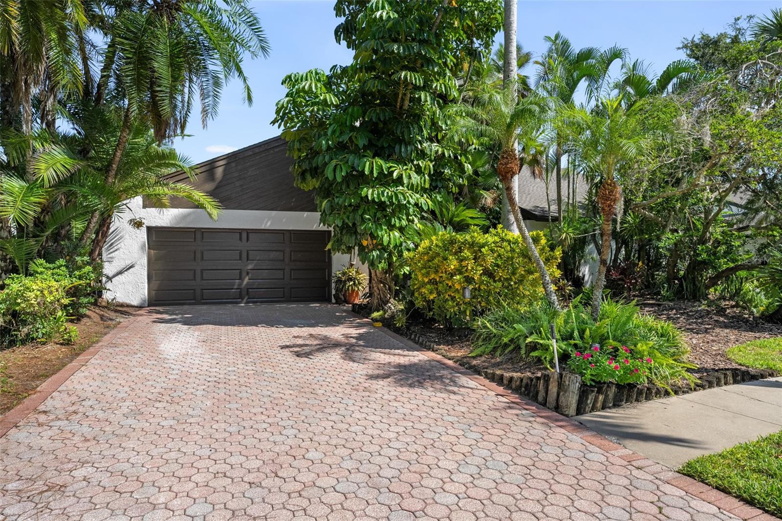 Welcome to 14506 Anchoret Road, a rare and remarkable mid-century modern gem nestled in the highly sought-after community of Carrollwood. This stunning 4-bedroom, 3-bathroom home offers a nostalgic escape into the timeless elegance of the 1970s while still embracing the comfort and flow of modern living. With dramatic architecture, soaring vaulted ceilings, and walls of windows that bathe the home in natural light, this residence is truly one of a kind. From the moment you arrive, you'll feel transported. Clean lines, angular details, and mature landscaping set the stage for what awaits inside. Step through the front door and be immediately greeted by a split floor plan filled with warmth, light, and character. The expansive living areas offer both a formal living room and a more relaxed family room—complete with a built in bar, ideal for entertaining in style. Two dining spaces give you the flexibility to host elegant dinners or casual game nights. Currently, one of the dining areas is playfully used as a billiards room, showcasing just how versatile this layout truly is. The oversized windows throughout the home create a seamless connection between indoors and out, flooding every room with sunshine and allowing views of the lush backyard oasis. Each of the four bedrooms is generously sized, offering ample room to unwind. The bathrooms are spacious as well, with thoughtful vintage touches and plenty of room to add your own flair. The architectural details—like original built-ins, dramatic ceiling heights, and period lighting—give this home soul, while still providing the footprint and flow today’s homeowners crave. And then there's the pool—your private retreat. Step outside to a sparkling backyard pool surrounded by tropical greenery and ample patio space for lounging, grilling, and soaking in the Florida sun. Whether you’re hosting weekend pool parties or enjoying a quiet evening under the stars, this outdoor space completes the full experience of mid-century Florida living. Additional peace of mind comes with a brand new roof installed in 2022, allowing you to move in with confidence and enjoy your home for years to come. Located in charming Carrollwood, you’re just minutes from Tampa’s best dining, shopping, and entertainment, yet tucked into a quiet, established neighborhood full of character. This is more than just a home—it’s a lifestyle, a design statement, and a piece of history. Don’t miss the opportunity to make this one-of-a-kind property yours.