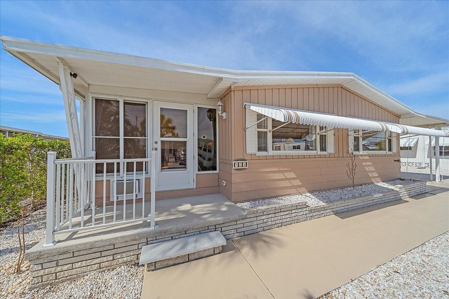 Welcome home to easy living and resort-style comfort in this beautifully updated TURN-KEY 2-bedroom, 2-bath residence located in the peaceful and highly desirable 55+ community of Venice Isle. Thoughtfully designed and impeccably maintained, this home offers the perfect blend of style, convenience, and carefree Florida living.  Step inside to a bright and welcoming OPEN-CONCEPT LAYOUT filled with natural light. The spacious living area flows seamlessly into the dining space and stunning modern kitchen, making it ideal for entertaining or simply relaxing in comfort. The kitchen is a showstopper, featuring sleek GRANITE COUNTERTOPS, a gorgeous coastal-inspired backsplash, updated lighting, TOP-OF-THE-LINE APPLIANCES, and generous cabinet storage. A conveniently located INDOOR LAUNDRY area sits just off the kitchen for everyday ease.  This home is equipped with a newer TANKLESS WATER HEATER, offering energy efficiency and endless hot water. Both bedrooms are generously sized and designed for relaxation. The primary suite is a private retreat with an EN-SUITE BATHROOM showcasing contemporary fixtures and finishes. The second bedroom is perfect for guests, hobbies, or a home office, with a full second bathroom nearby.  Outside, enjoy your own PRIVATE PAVER PATIO, an inviting space for morning coffee, evening cocktails, or entertaining under the stars. The property also features a 2-CAR COVERED CARPORT, plus an ADDITIONAL SIDE PAVER AREA that comfortably accommodates two more vehicles—a rare and valuable bonus.  To top it off, this home includes a GOLF CART with a canopy for storage, perfect for cruising the community in comfort, along with a 3-WHEELED BIKE ready for exploring Venice and beyond.  In addition, there's a high quality Weber Gas Grill for your outdoor cooking enjoyment! The LOW-MAINTENANCE rock landscaping keeps upkeep minimal so you can focus on enjoying life. The UPDATED ENTRY DOORS include a glass storm door and a modern paneled door with KEYLESS ENTRY, adding both style and convenience.  If you're still not convinced, the seller recently had an inspection done for this house and it came back with close to a perfect mark - talk about buyer confidence! Living in Venice Isle means enjoying some of the area’s most impressive amenities, including two resort-style pools (heated in winter and cooled in summer), two hot tubs, saunas, fitness center, tennis courts, bocce ball, cornhole, horseshoes, putt-putt golf, billiards, ping pong, game room, Tiki Hut, and a vibrant clubhouse. Even better—FREE TRANSPORTATION is provided to medical appointments, shopping, dining, and local outings. With an active calendar of social events and activities, there’s always something to enjoy and neighbors to meet.  The LOW HOA FEE covers fiber optic cable TV & internet, lawn maintenance, and all amenities, making this an exceptional value. Ideally located close to shopping, dining, and medical facilities, this home truly offers the best of both convenience and tranquility.  Offered fully turn-key, this is your chance to move right in and start living the lifestyle you deserve. Schedule your private showing today and discover just how effortless and enjoyable life can be in this exceptional community.